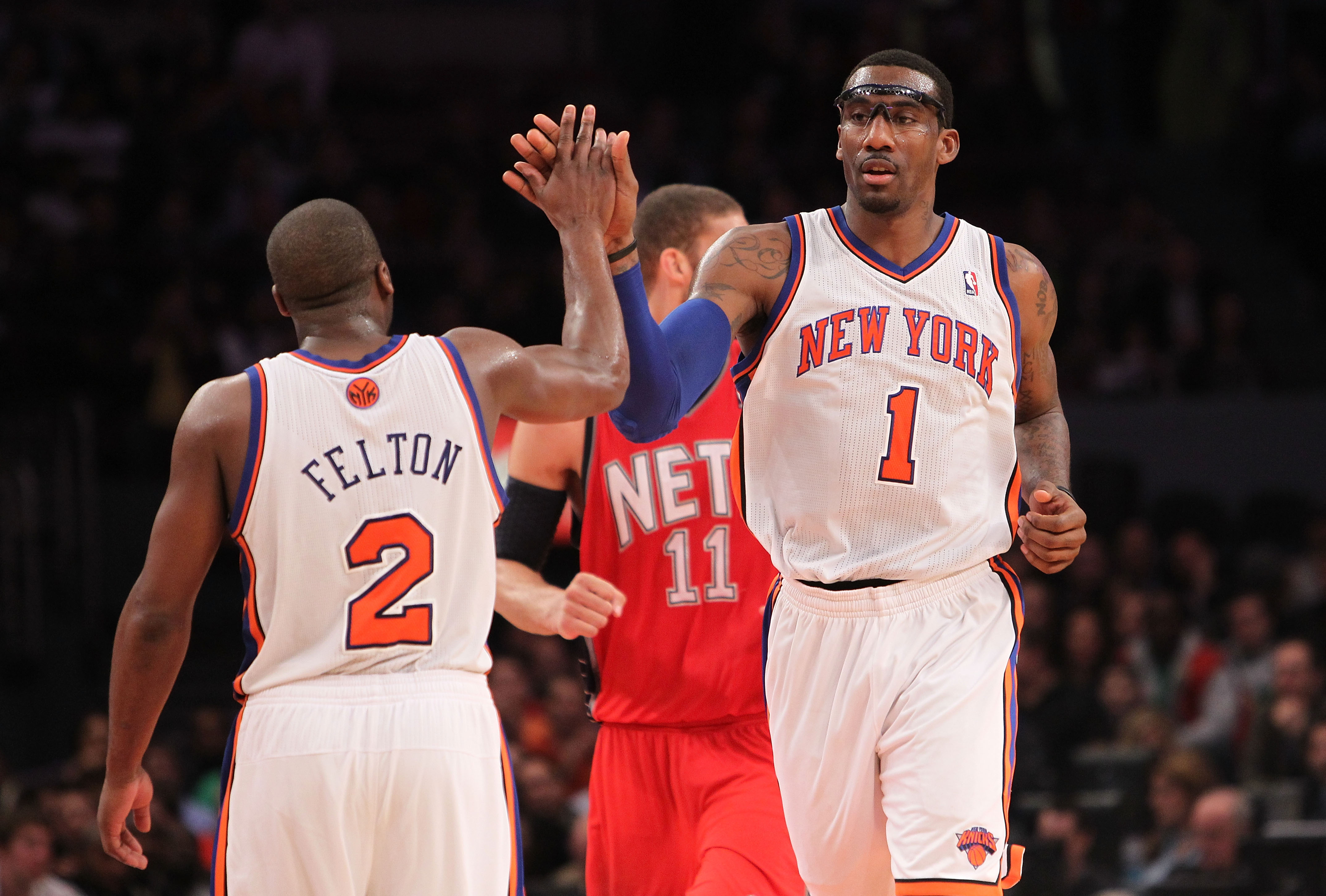 NEW YORK, NY - NOVEMBER 30:  Amar'e Stoudemire #1 of the New York Knicks high fives teammate Raymond Felton #2l against the New Jersey Nets on November 30, 2010 at Madison Square Garden in New York City. NOTE TO USER: User expressly acknowledges and agree