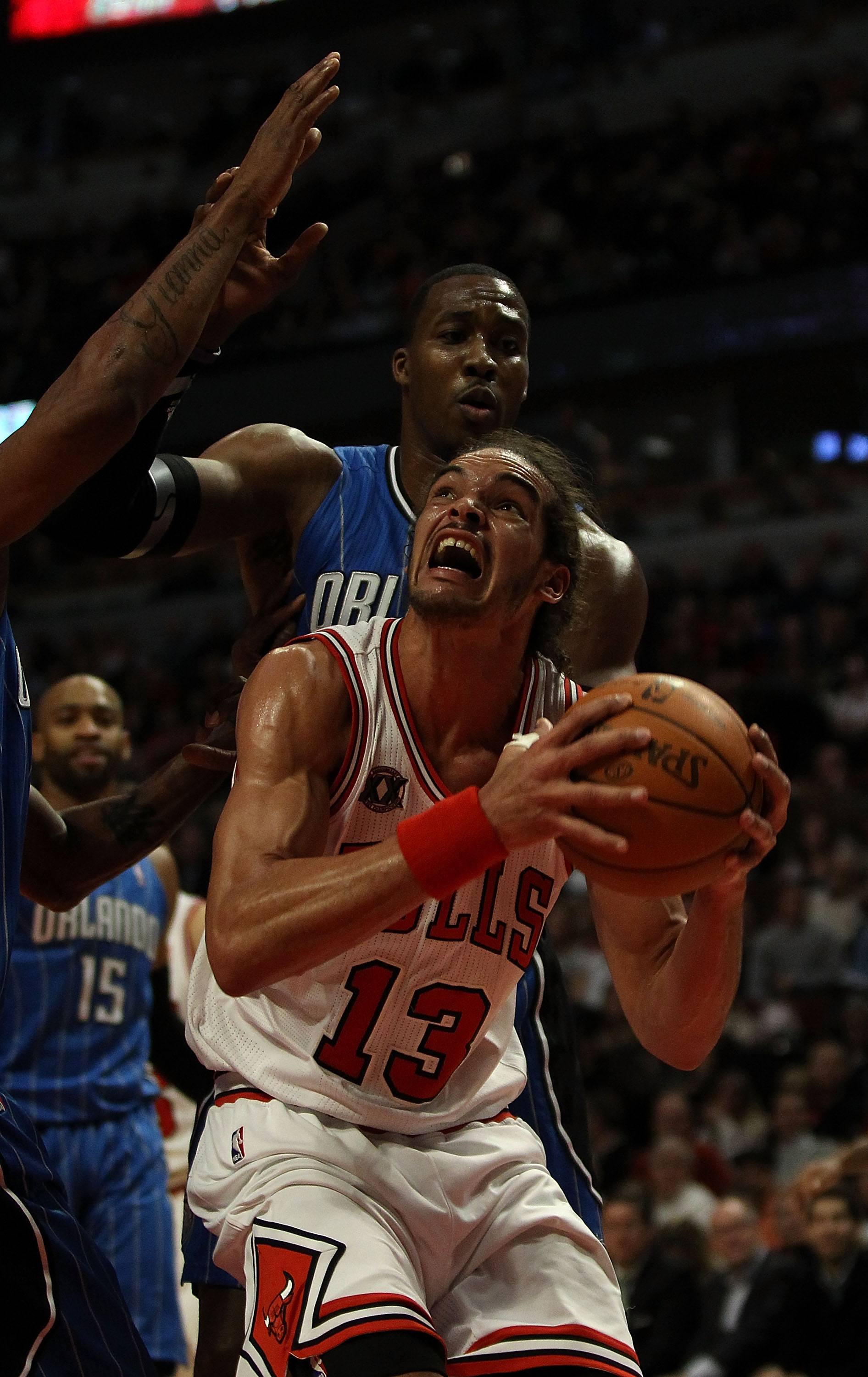 CHICAGO, IL - DECEMBER 01: Joakim Noah #13 of the Chicago Bulls goes up for a shot against Dwight Howard #12 of the Orlando Magic at the United Center on December 1, 2010 in Chicago, Illinois. The Magic defeated the Bulls 107-78. NOTE TO USER: User expres