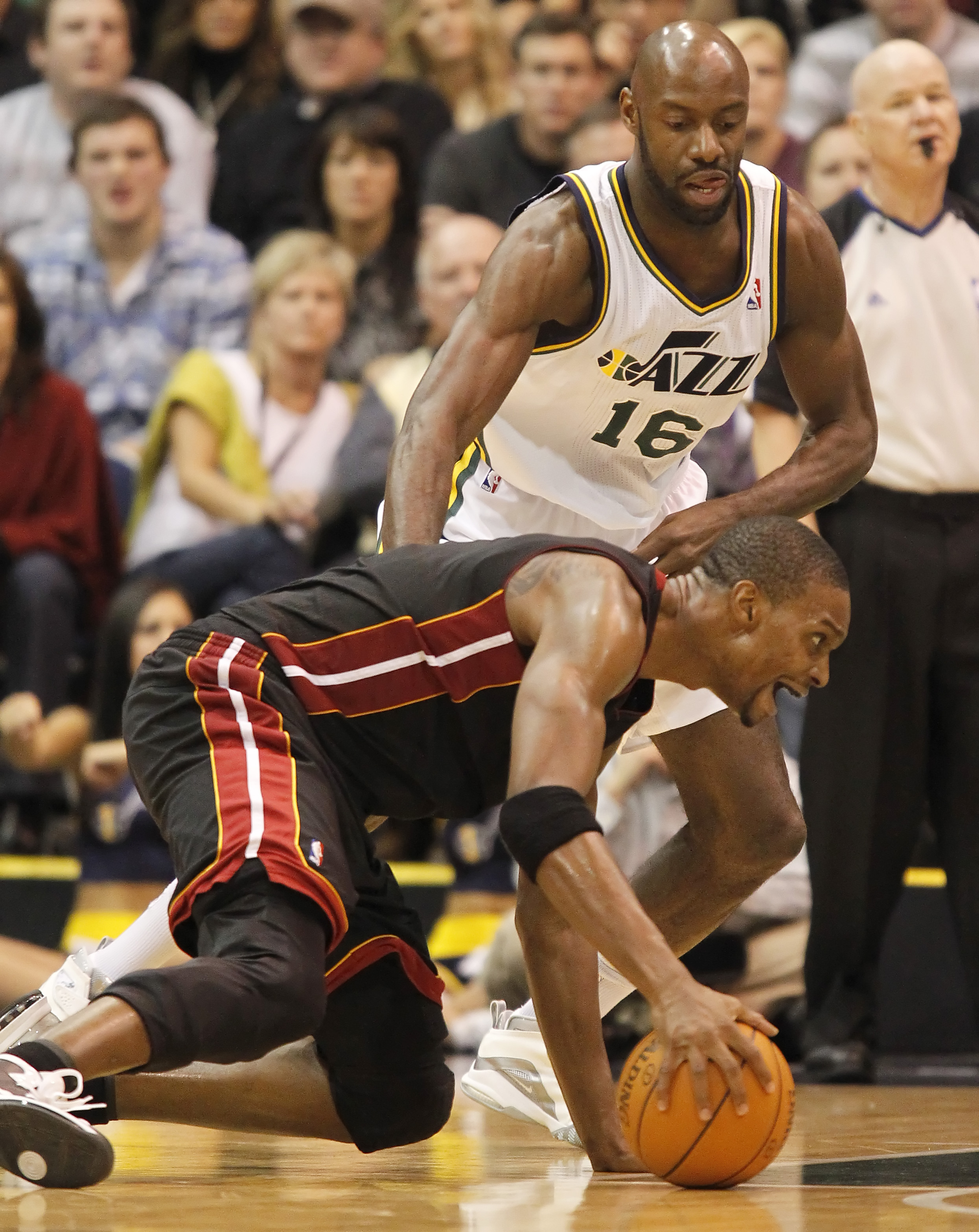 SALT LAKE CITY, UT - DECEMBER 8: Chris Bosh #1 of the Miami Heat falls to the ground as Francisco Elson #16 of the Utah Jazz during the second half of an NBA game December 8, 2010 at Energy Solutions Arena in Salt Lake City, Utah. The Heat beat the Jazz 1