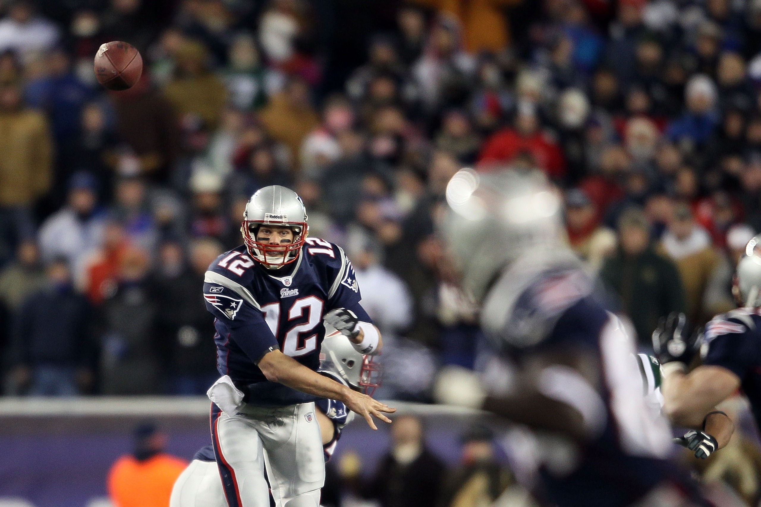 FOXBORO, MA - DECEMBER 06:  Tom Brady #12 of the New England Patriots throws a pass to Deion Branch #84 against the New York Jets at Gillette Stadium on December 6, 2010 in Foxboro, Massachusetts.  (Photo by Elsa/Getty Images)