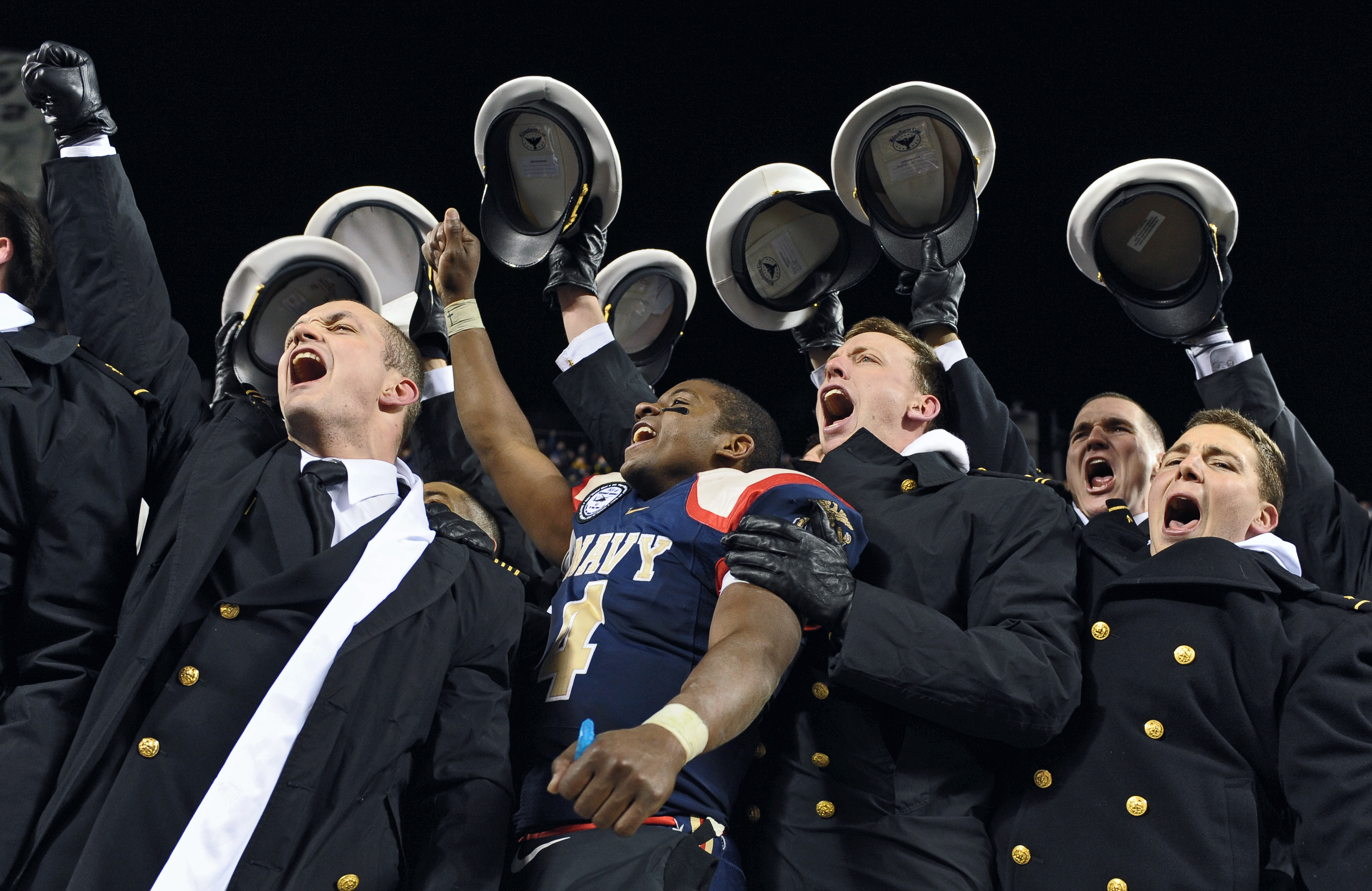 PHILADELPHIA - DECEMBER 12: Quarterback Ricky Dobbs #4 of the Navy Midshipmen, and game MVP, celebrates their 17-3 victory over the Army Black Knights on December 12, 2009 at Lincoln Financial Field in Philadelphia, Pennsylvania. (Photo by Drew Hallowell/