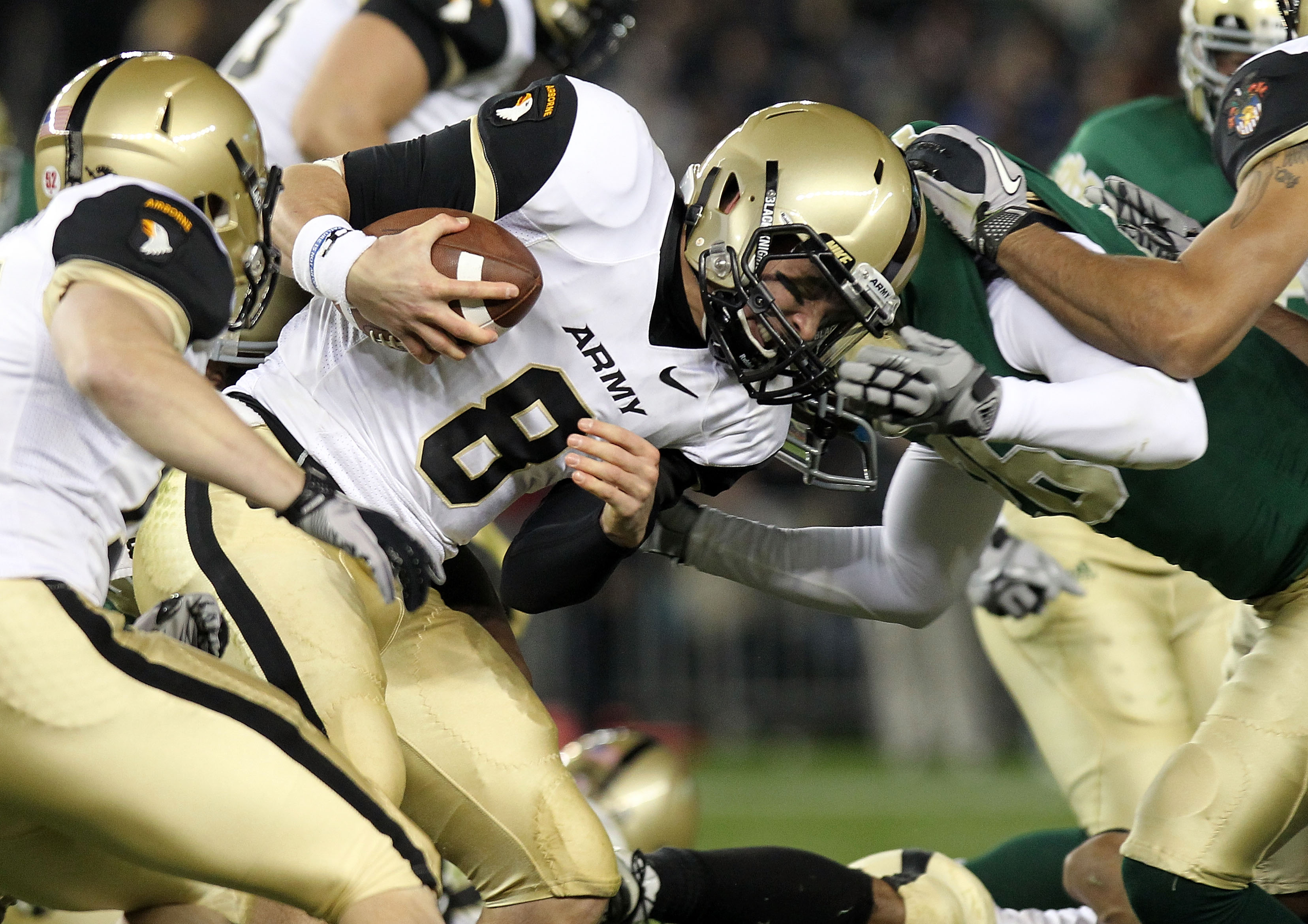 NEW YORK - NOVEMBER 20: Trent Steelman #8 of the Army Black Knights is tackled against the Notre Dame Fighting Irish at Yankee Stadium on November 20, 2010 in the Bronx borough of New York City. (Photo by Nick Laham/Getty Images)