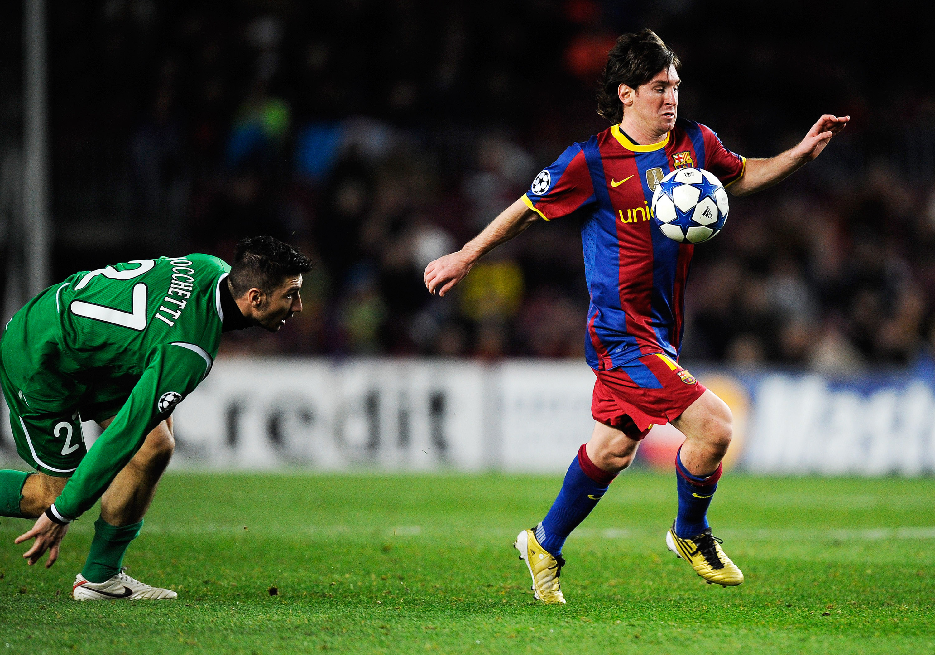 BARCELONA, SPAIN - DECEMBER 07:  Salvatore Bocchetti of Rubin Kazan looks to Lionel Messi of Barcelona as he controls the ball during the Csampions League match between Barcelona and Rubin Kazan at Camp Nou Stadiumon December 7, 2010 in Barcelona, Spain.