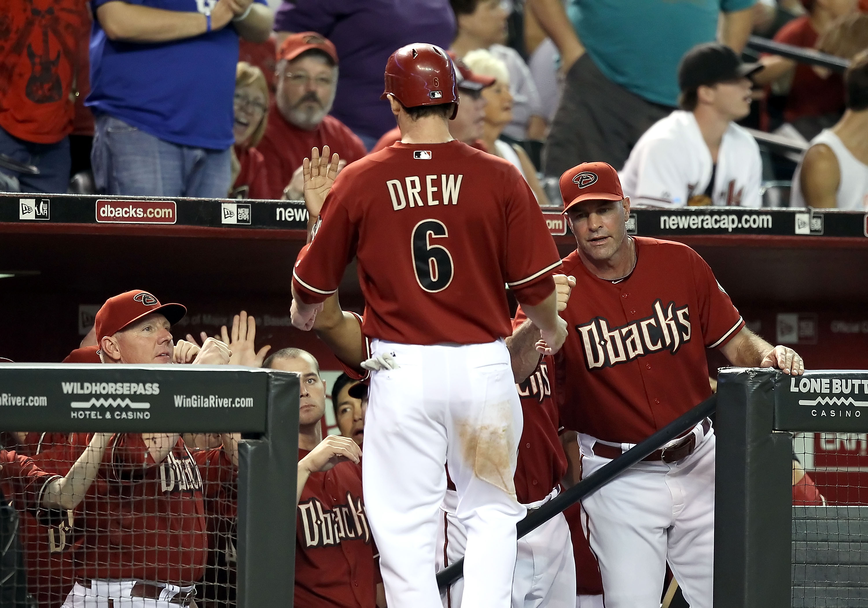 PHOENIX - AUGUST 18:  Manager Kirk Gibson of the Arizona Diamondbacks greets Stephen Drew #6 after he scored against the Cincinnati Reds during the Major League Baseball game at Chase Field on August 18, 2010 in Phoenix, Arizona. The Reds defeated the Dia