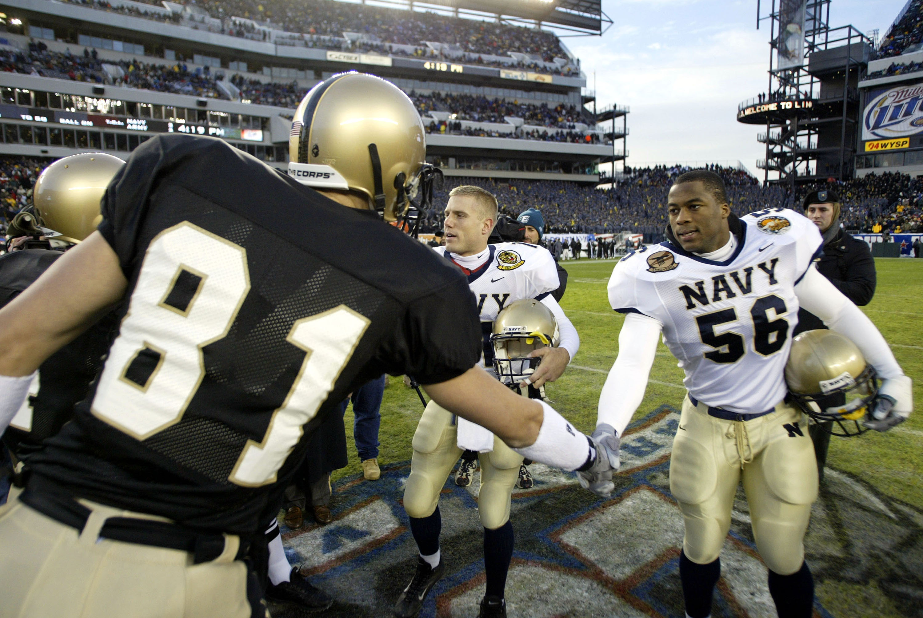 PHILADELPHIA - DECEMBER 6: Eddie Carthan #56 of the Navy shakes hands with Clint Woody #81 of the Army at the Lincoln Financial Field Stadium on December 6, 2003 in Philadelphia, Pennsylvania. The Navy defeated the Army 34-6. (Photo by Chris Trotman/Get