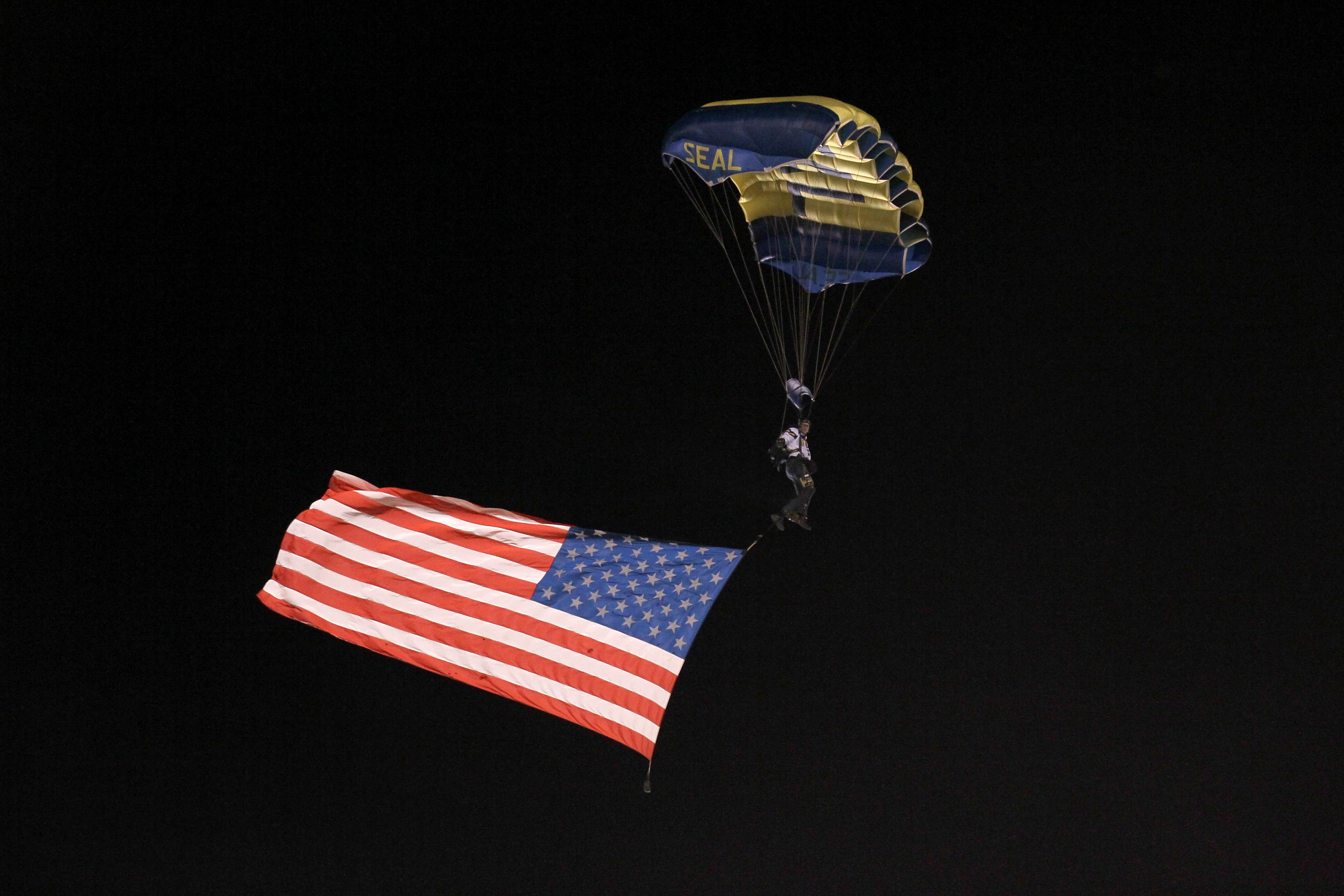 SAN DIEGO - NOVEMBER 22: The US Navy Seal Leapfrog parachute team bring in an American flag before the game between the Denver Broncos and the San Diego Chargers at Qualcomm Stadium on November 22, 2010 in San Diego, California. (Photo by Stephen Dunn/G