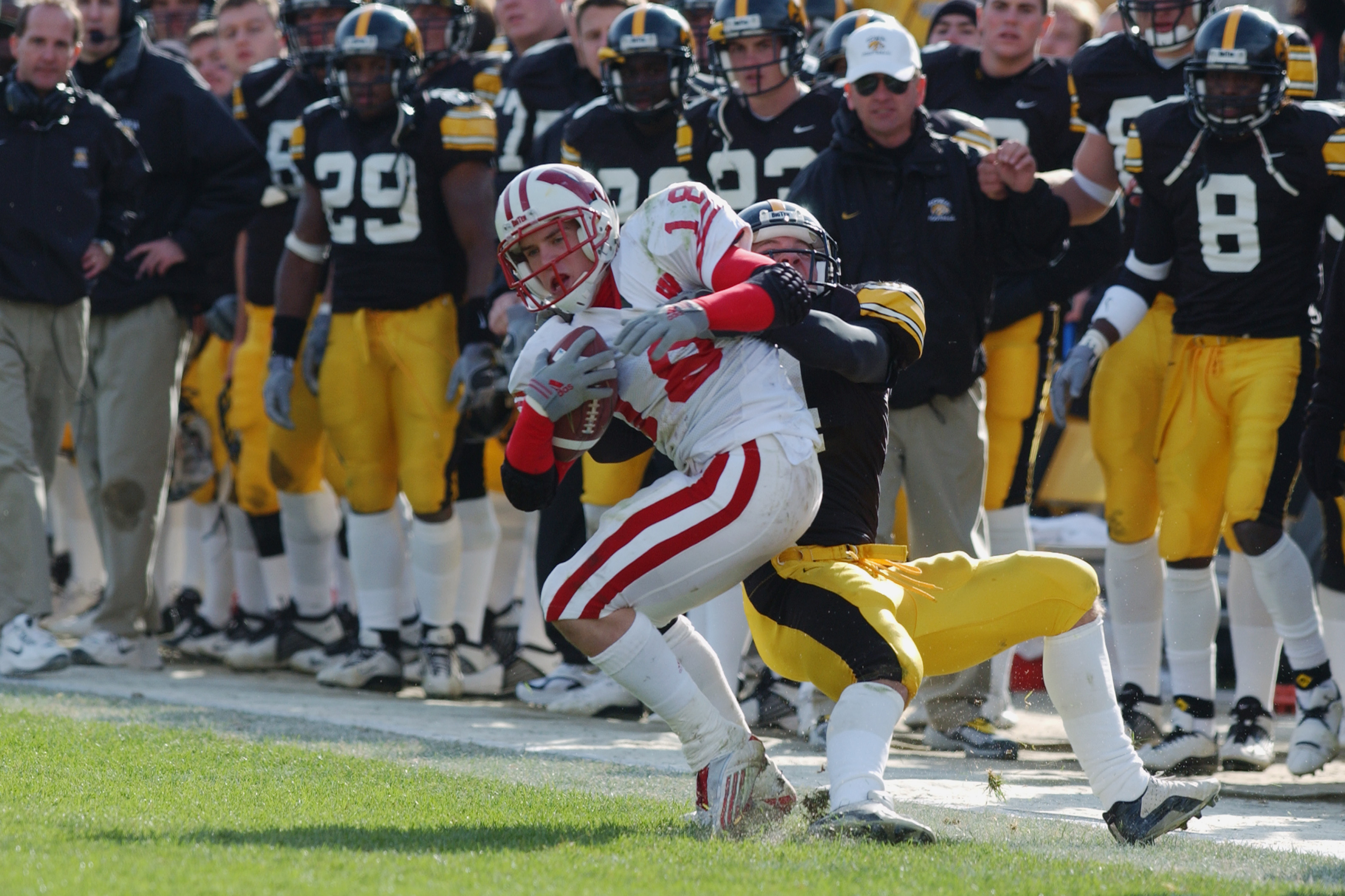 IOWA CITY, IA - NOVEMBER 2:  Jim Leonhard #18 of the Wisconsin Badgers is thrown out of bounds by Scott Boleyn #4 of the Iowa Hawkeyes during the game on November 2, 2002 at Kinnick Stadium in Iowa City, Iowa.  (Photo by Matthew Stockman/Getty Images)