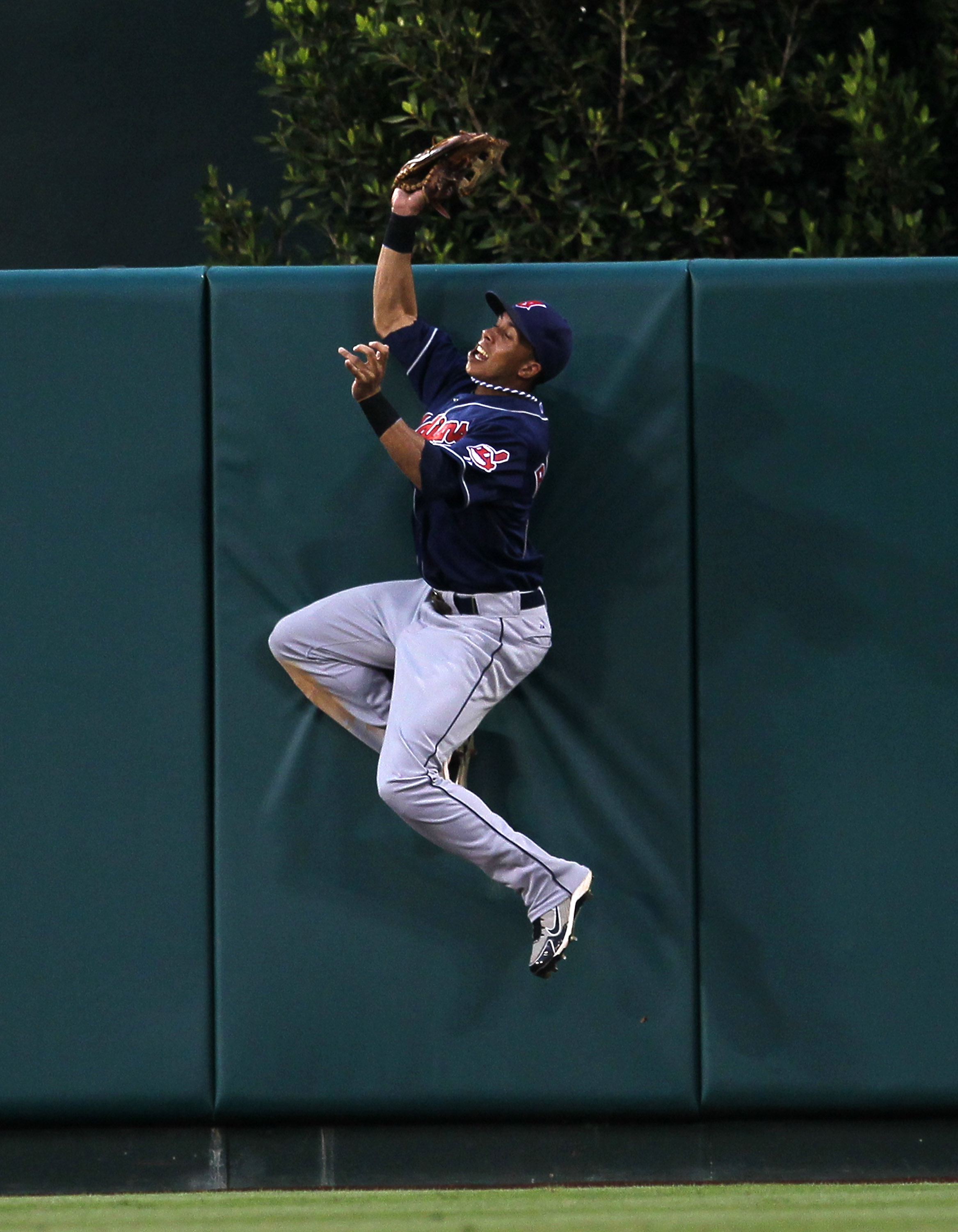 ANAHEIM, CA - SEPTEMBER 08:  Center fielder Michael Brantley #23 of the Cleveland Indians jumps to catch a ball at the wall and deny a bid for a walk off home run by Juan Rivera #20 of the Los Angeles Angels of Anaheim in the tenth inning on September 8,