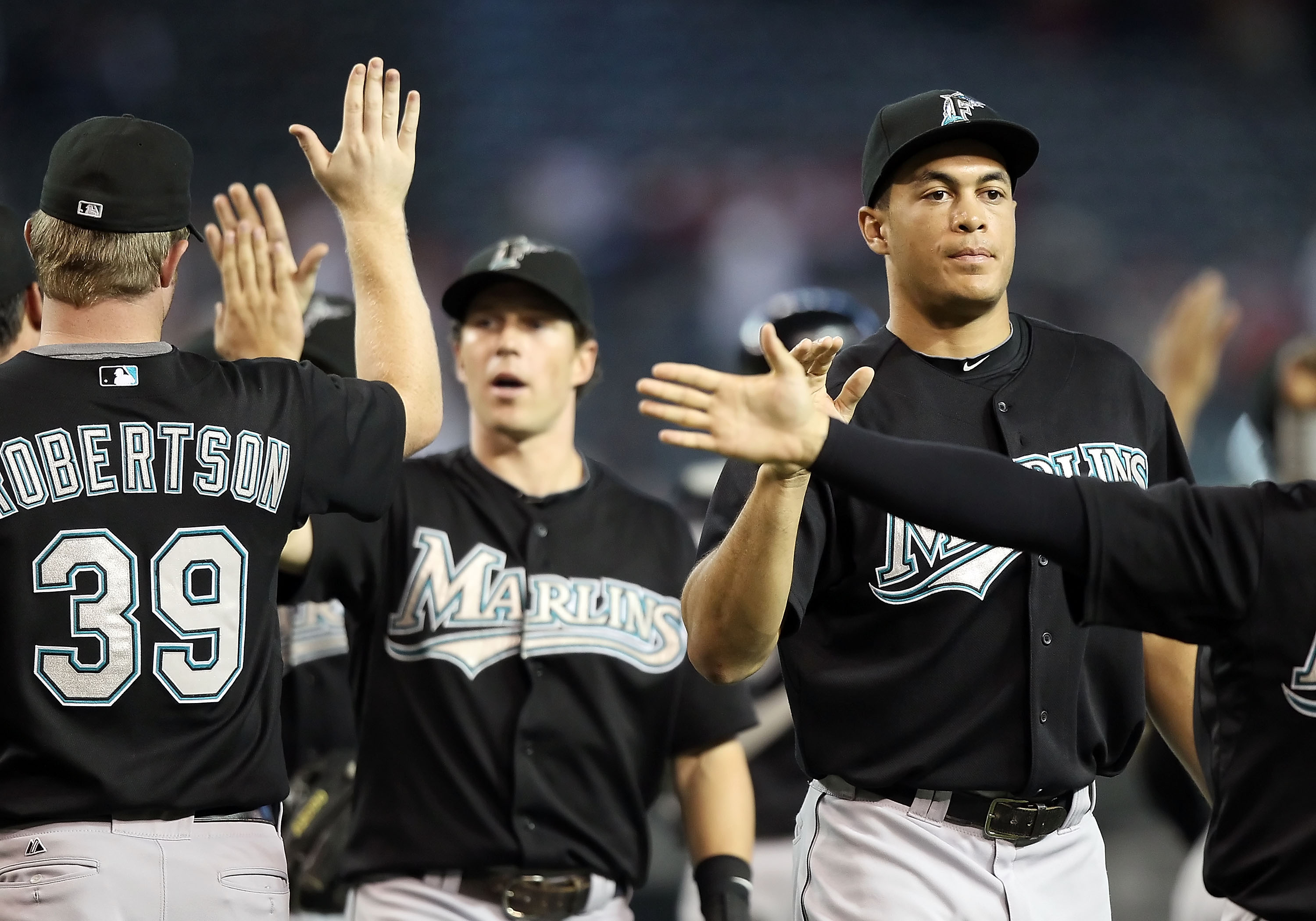 PHOENIX - JULY 11:  Mike Stanton #27 of the Florida Marlins high fives teammates after defeating the Arizona Diamondbacks in the Major League Baseball game at Chase Field on July 11, 2010 in Phoenix, Arizona.  The Marlins defeated the Diamondbacks 2-0.  (
