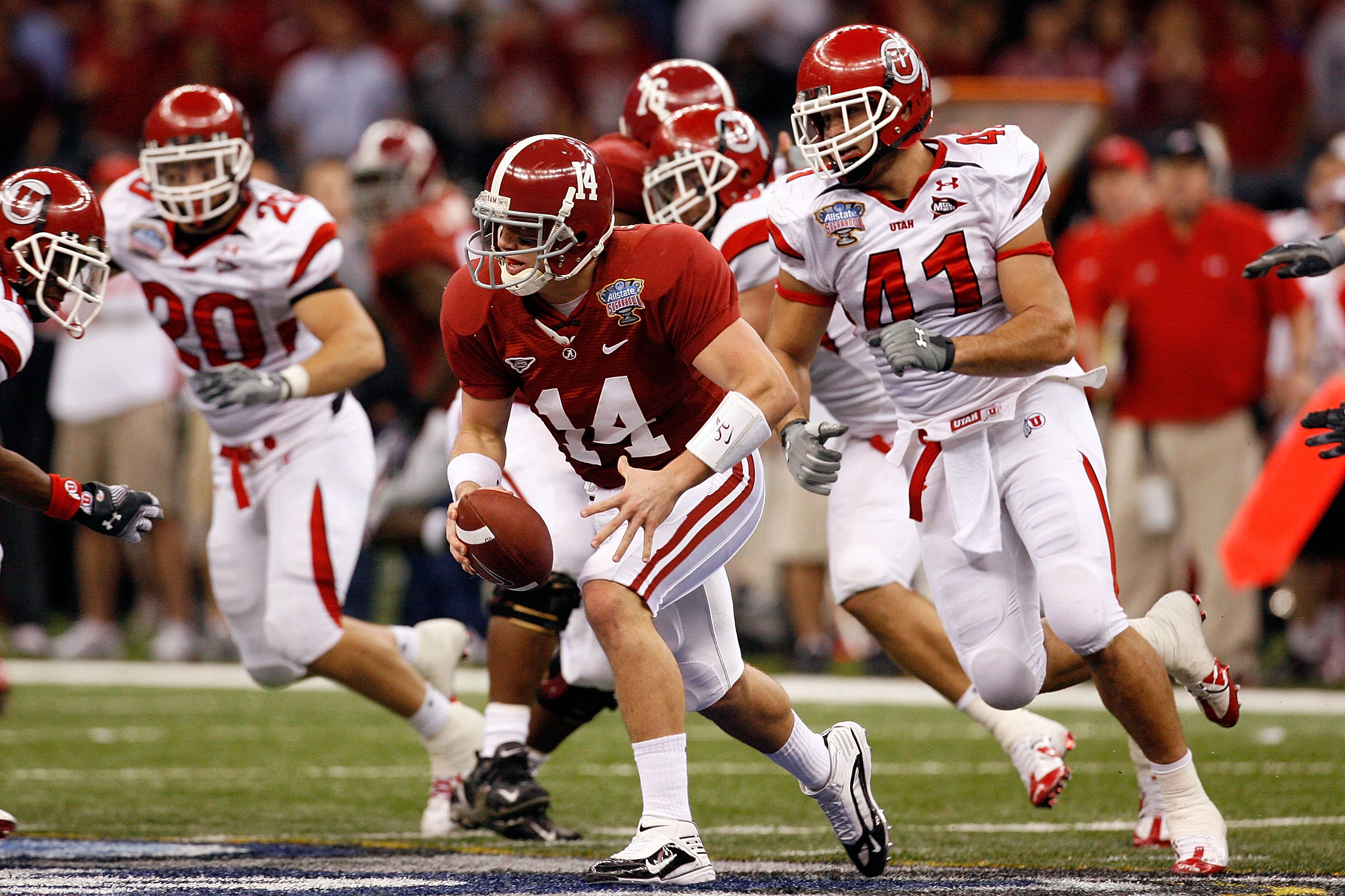 NEW ORLEANS - JANUARY 02: Quarterback John Parker Wilson #14 of the Alabama Crimson Tide runs as he is chased by defensive lineman Koa Misi #41 of the Utah Utes in the second half during the 75th Allstate Sugar Bowl at the Louisiana Superdome on January