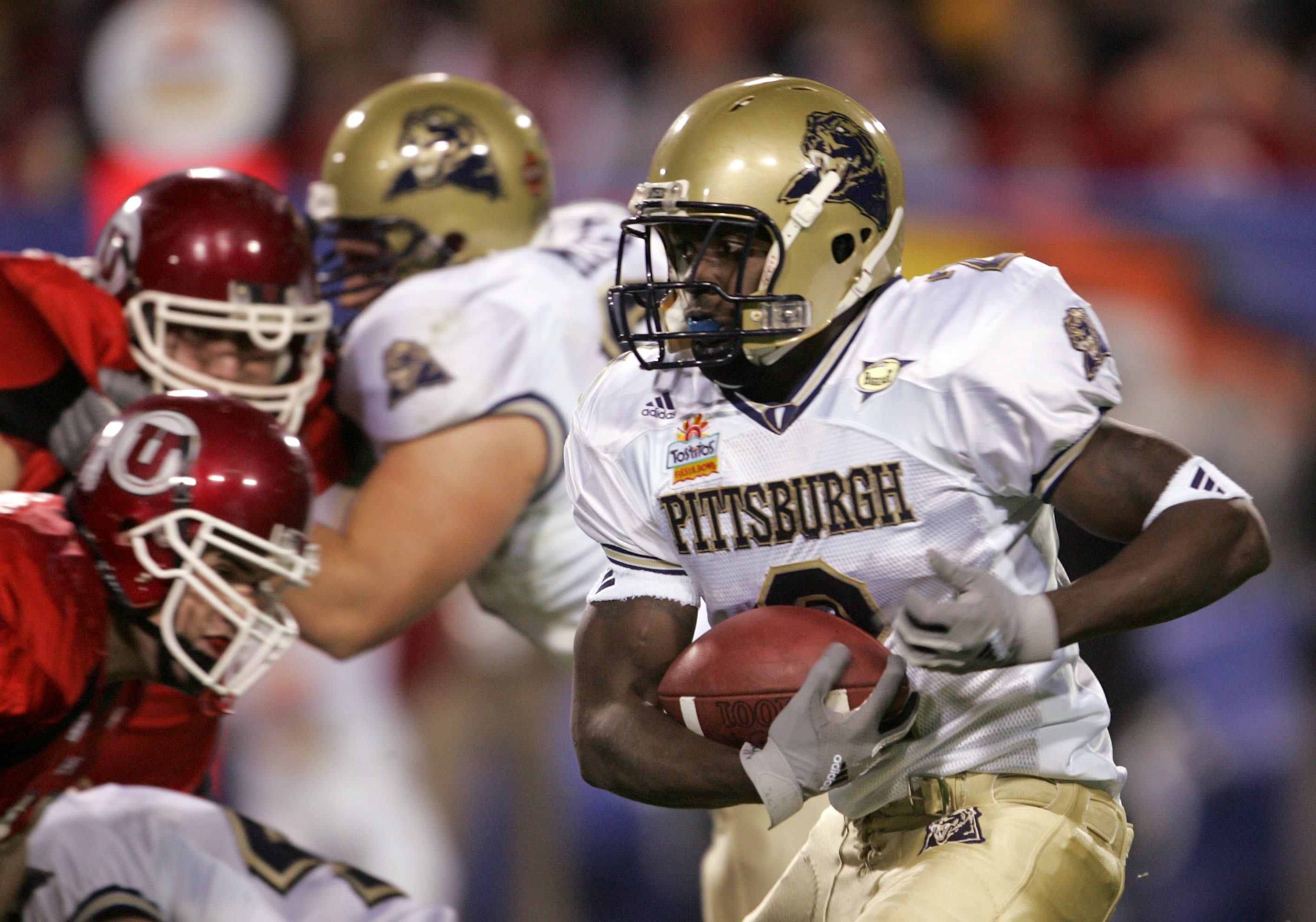TEMPE, AZ - JANUARY 1: Marcus Furman #2 of Pittsburgh runs the ball against Utah in the Tostito's Fiesta Bowl at the Sun Devil Stadium on January 1, 2005 in Tempe, Arizona. Utah would win the game 35-7. (Photo by Jeff Gross/Getty Images).