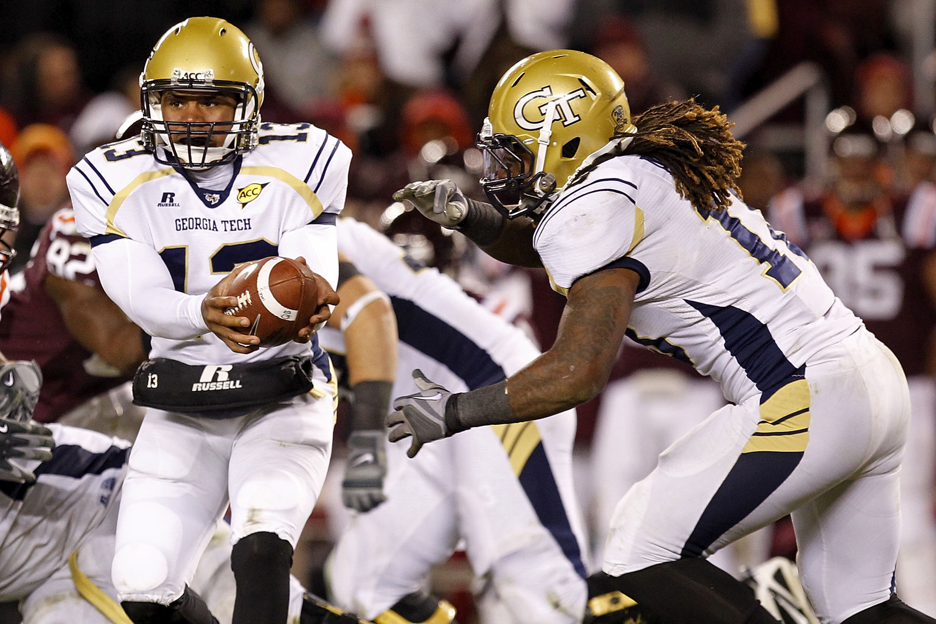 BLACKSBURG, VA - NOVEMBER 04: Quarterback Tevin Washington #13 of the Georgia Tech Yellow Jackets hands the ball off to running back Anthony Allen #18 of the Georgia Tech Yellow Jackets against the Virginia Tech Hokies at Lane Stadium on November 4, 2010