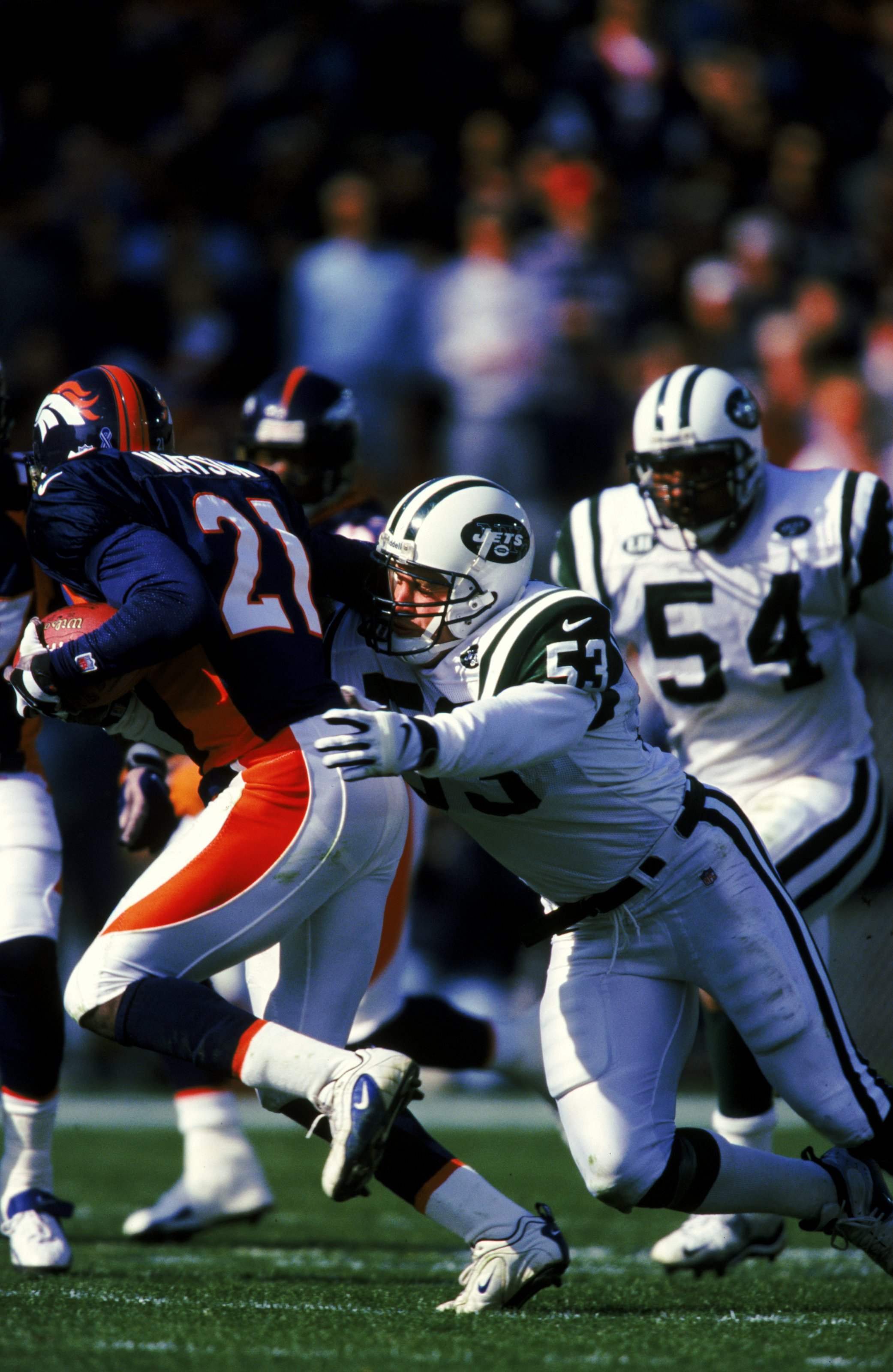 3 Oct 1999: Chad Cascadden #53 of the New York Jets tries to tackle Chris Watson #21 of the Denver Broncos during the game at the Mile High Stadium in Denver, Colorado. The Jets defeated the Broncos 21-13.