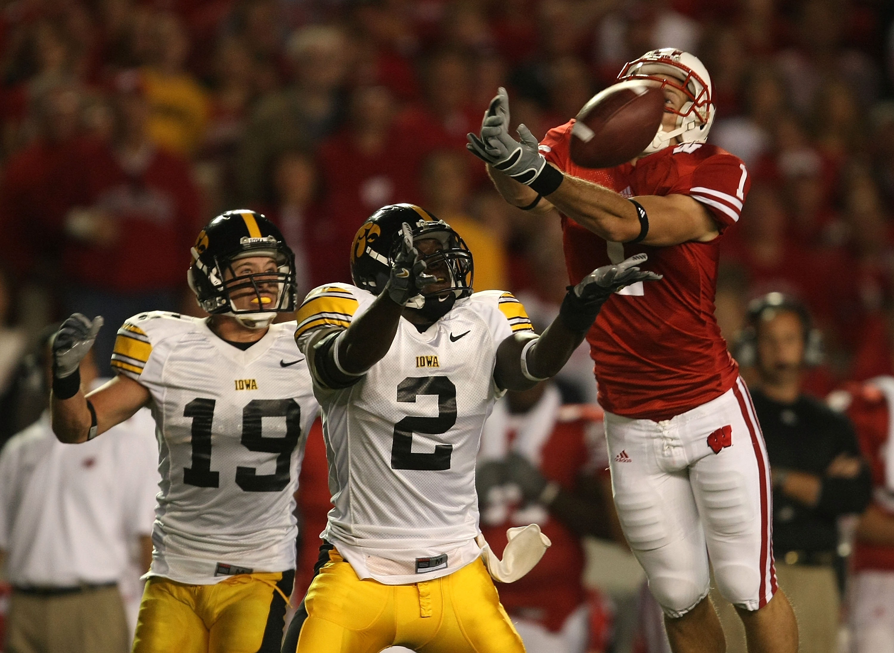 MADISON, WI - SEPTEMBER 22:  Luke Swan #1 of the Wisconsin Badgers misses a catch as Harold Dalton #2 and Adam Shada #19 of the Iowa Hawkeyes defend at Camp Randall Stadium September 22, 2007 in Madison, Wisconsin.  (Photo by Jonathan Daniel/Getty Images)