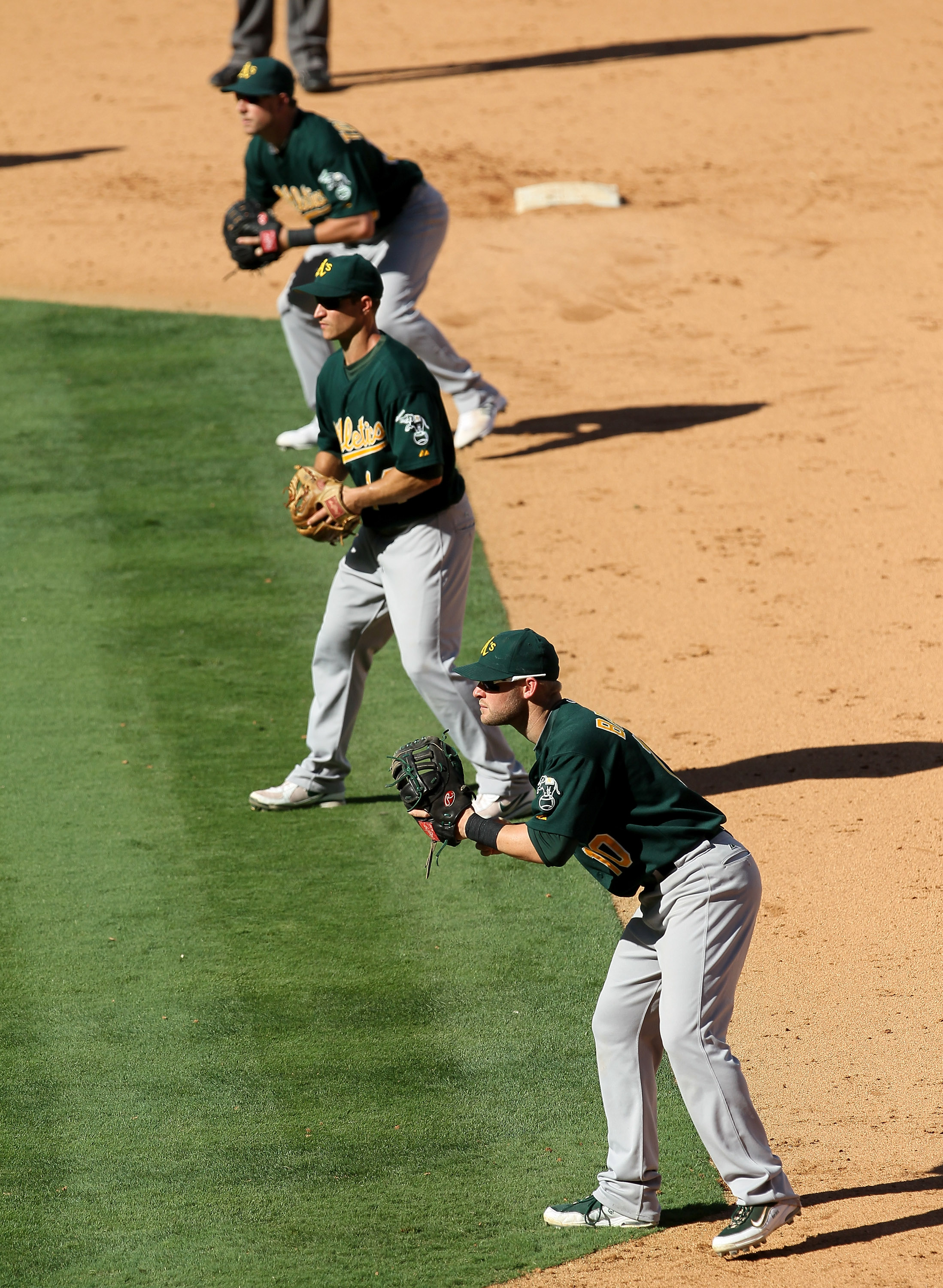 ANAHEIM, CA - SEPTEMBER 29:  First baseman Daric Barton #14, second baseman Mark Ellis #14, and extra infielder Steven Tolleson #30 of the Oakland Athletics fill the right side of the infield as the Los Angeles Angels of Anaheim bat with the bases loaded,