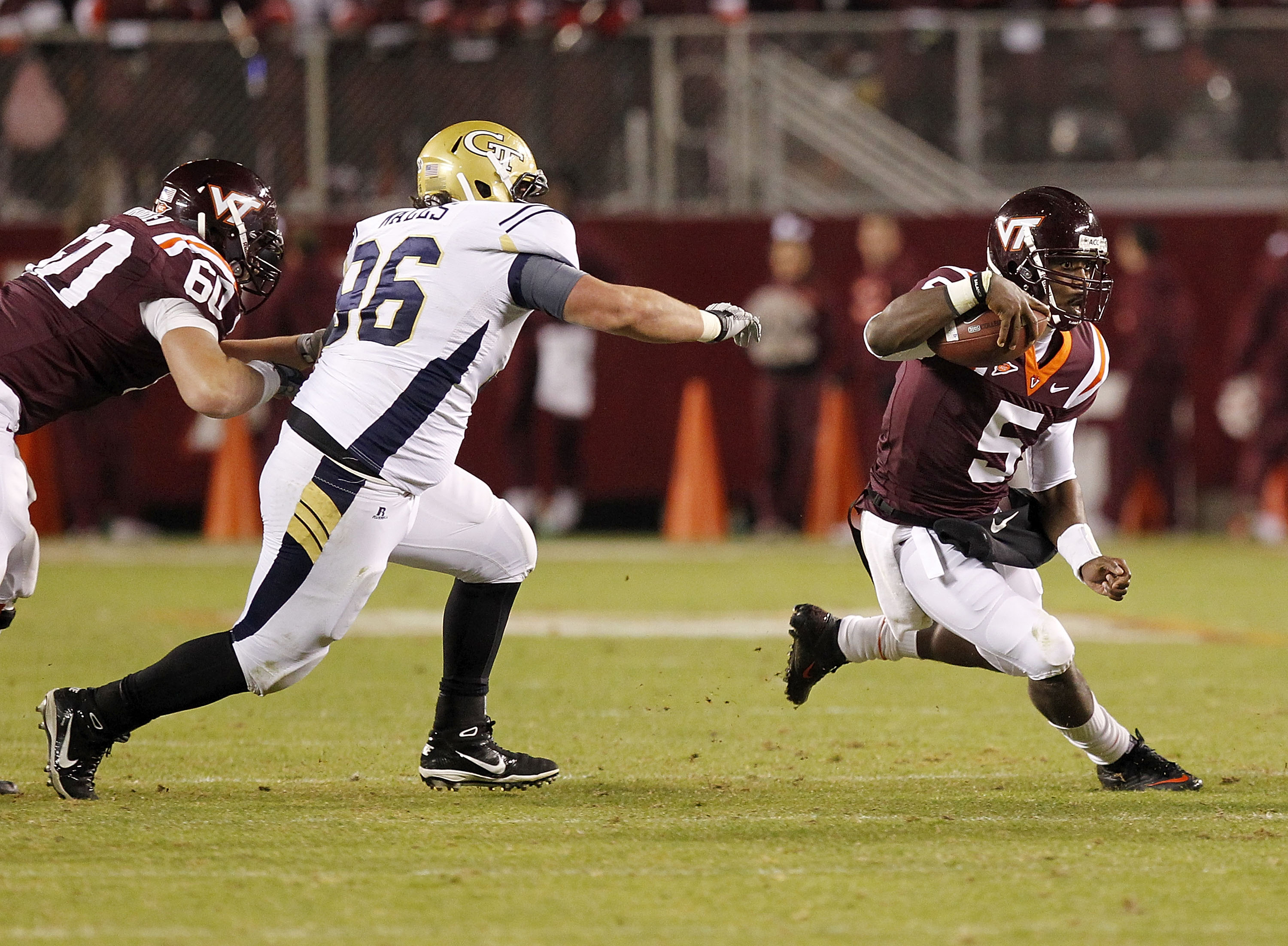 BLACKSBURG, VA - NOVEMBER 04: Quarterback Tyrod Taylor #5 of the Virginia Tech Hokies runs with the ball as defensive tackle Logan Walls #96 of the Georgia Tech Yellow Jackets chases at Lane Stadium on November 4, 2010 in Blacksburg, Virginia. (Photo by