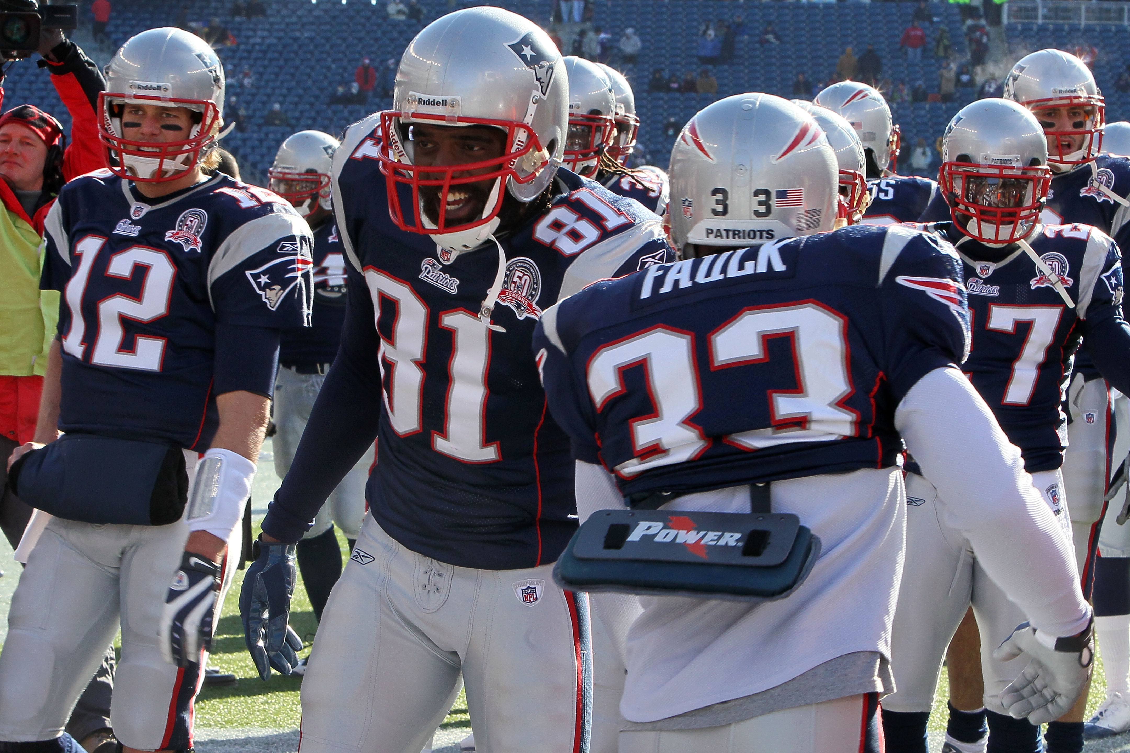FOXBORO, MA - JANUARY 10:  Tom Brady #12 and Randy Moss #81 of the New England Patriots greet their teammates on the field during warm ups against the Baltimore Ravens during the 2010 AFC wild-card playoff game at Gillette Stadium on January 10, 2010 in F