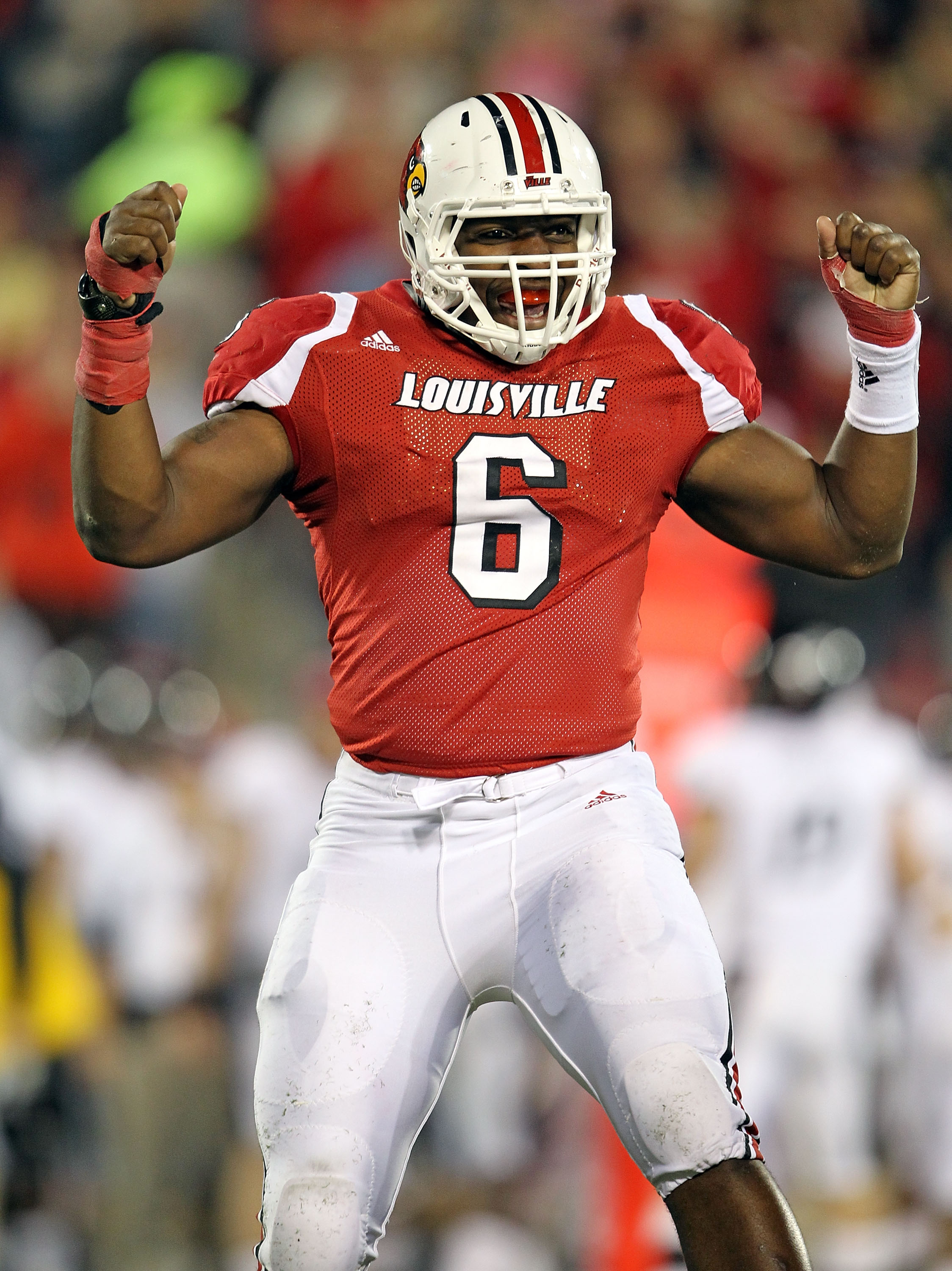 LOUISVILLE, KY - OCTOBER 15:  Greg Scruggs #6 of  the Louisville Cardinals  celebrates after intercepting a pass during the Big East Conference game against the Cincinnati Bearcats at Papa John's Cardinal Stadium on October 15, 2010 in Louisville, Kentuck