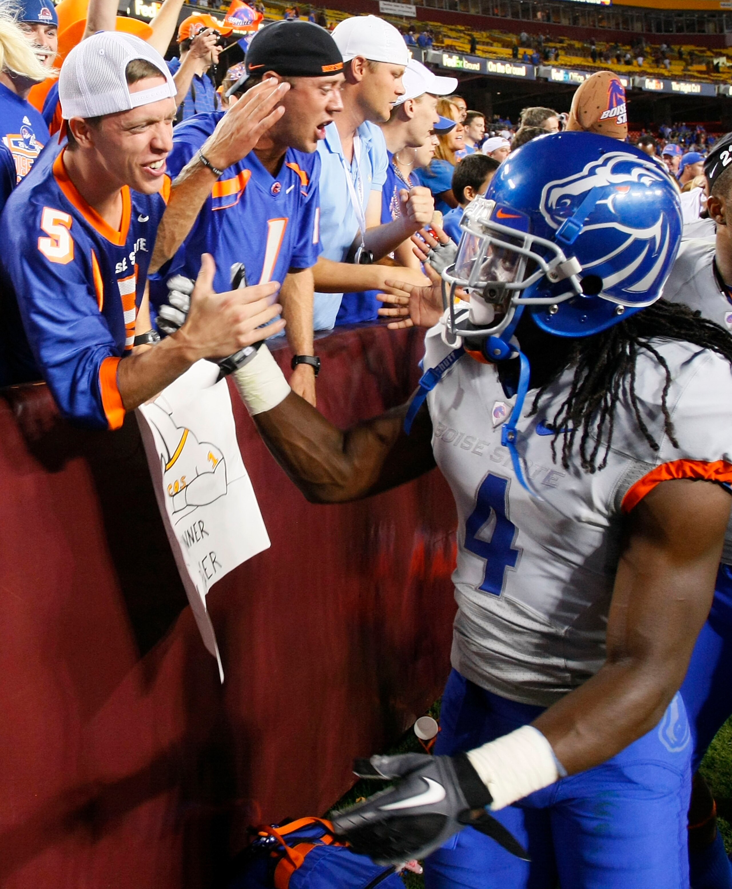LANDOVER, MD - SEPTEMBER 06: Defensive back Jerrell Gavins #4 of the Boise State Broncos shakes hands with a fan in the stands after the Broncos defeated the Virginia Tech Hokies 33-30 at FedExField on September 6, 2010 in Landover, Maryland. (Photo by LANDOVER, MD - SEPTEMBER 06: Defensive back Jerrell Gavins #4 of the Boise State Broncos shakes hands with a fan in the stands after the Broncos defeated the Virginia Tech Hokies 33-30 at FedExField on September 6, 2010 in Landover, Maryland. (Photo by