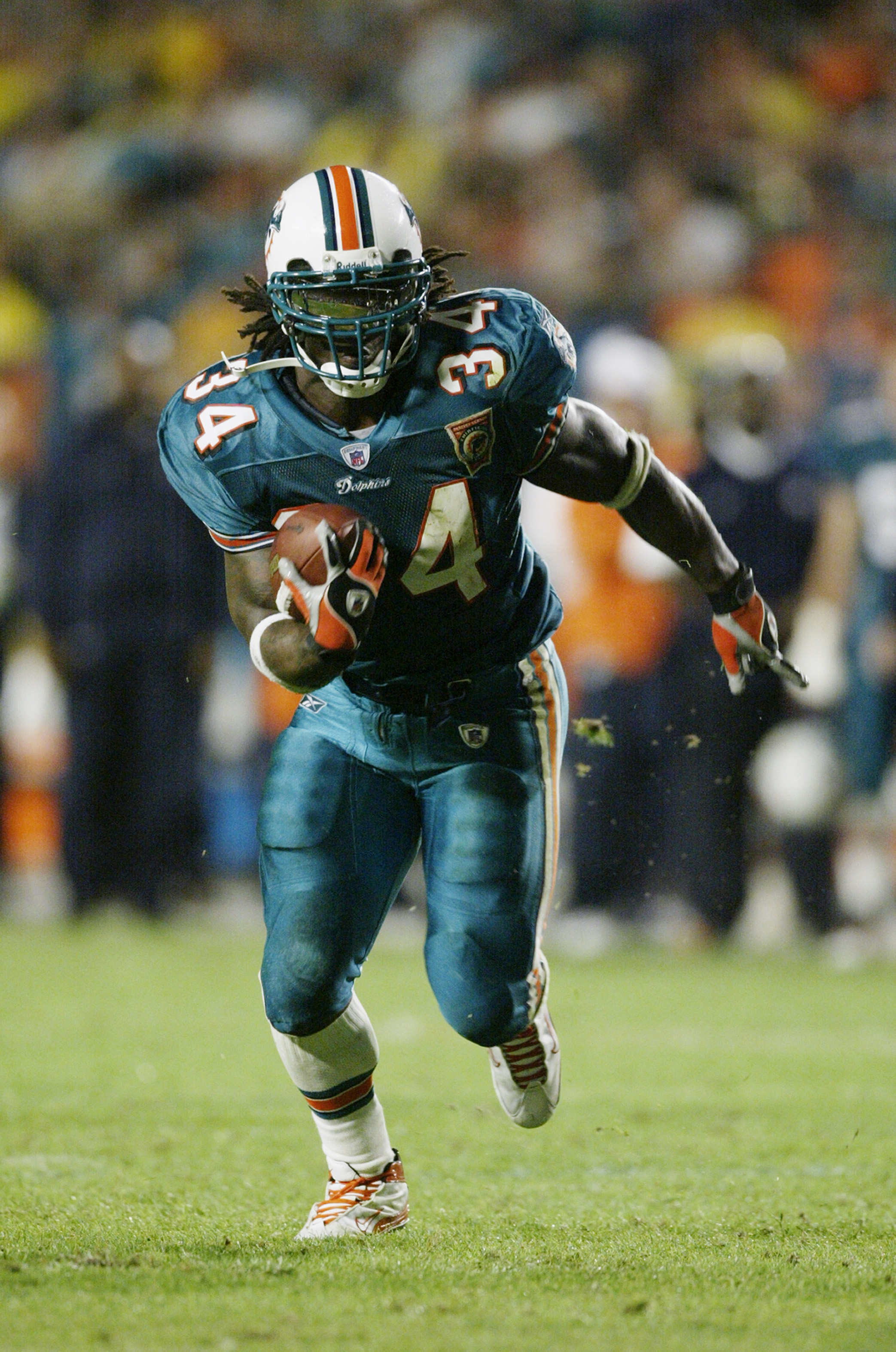 MIAMI, FL - DECEMBER 9:  Running back Ricky Williams #34 of the Miami Dolphins runs against the Chicago Bears during the game at Pro Player Stadium on December 9, 2002 in Miami, Florida. The Dolphins defeated the Bears 27-9. (Photo by Jed Jacobsohn/Getty