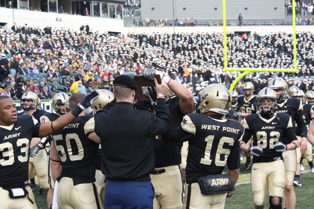 Army Touches the Plaque that Recalls the need for a West Point football player for a dangerous mission.