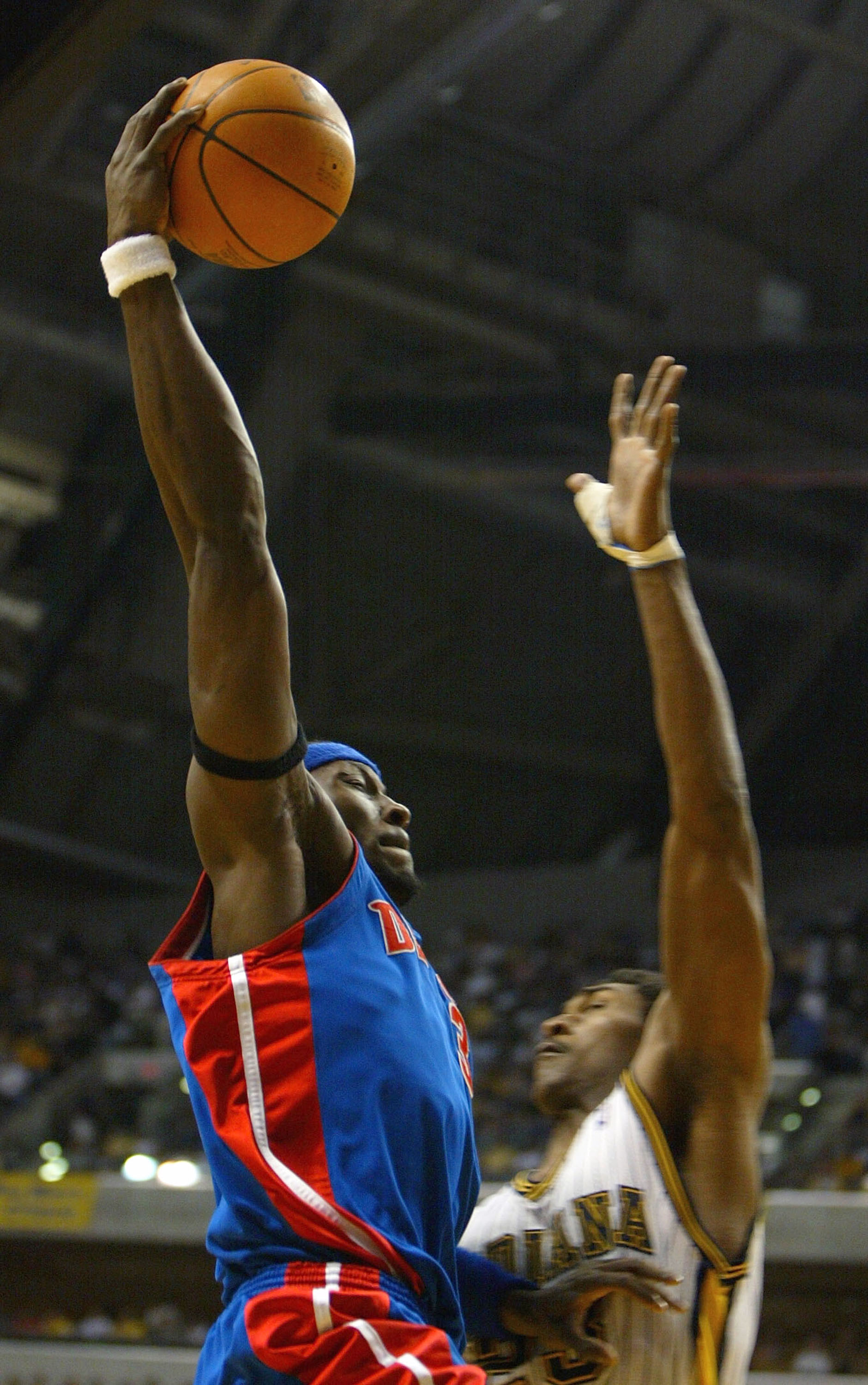 INDIANAPOLIS - MAY 24:  Ben Wallace #3 of the Detroit Pistons goes up for a basket over Ron Artest #23 of the Indiana Pacers in Game two of the Eastern Conference Finals during the 2004 NBA Playoffs at Conseco Fieldhouse on May 24, 2004 in Indianapolis, I