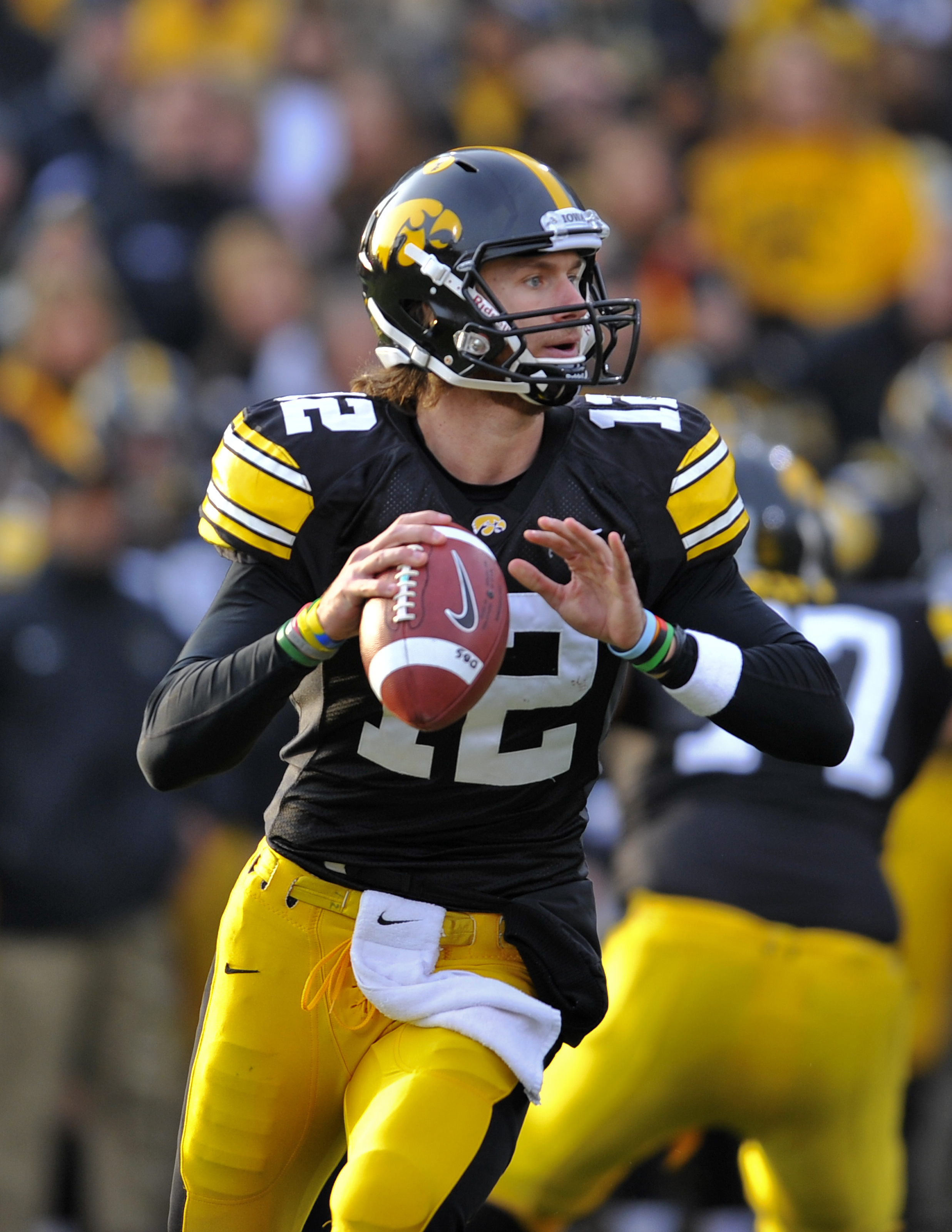 IOWA CITY, IA - NOVEMBER 20:  Quarterback Ricky Stanzi #12 of the University of Iowa Hawkeyes throws under pressure from Ohio State Buckeyes defenders during the first half of play at Kinnick Stadium on November 20, 2010 in Iowa City, Iowa. Ohio State won