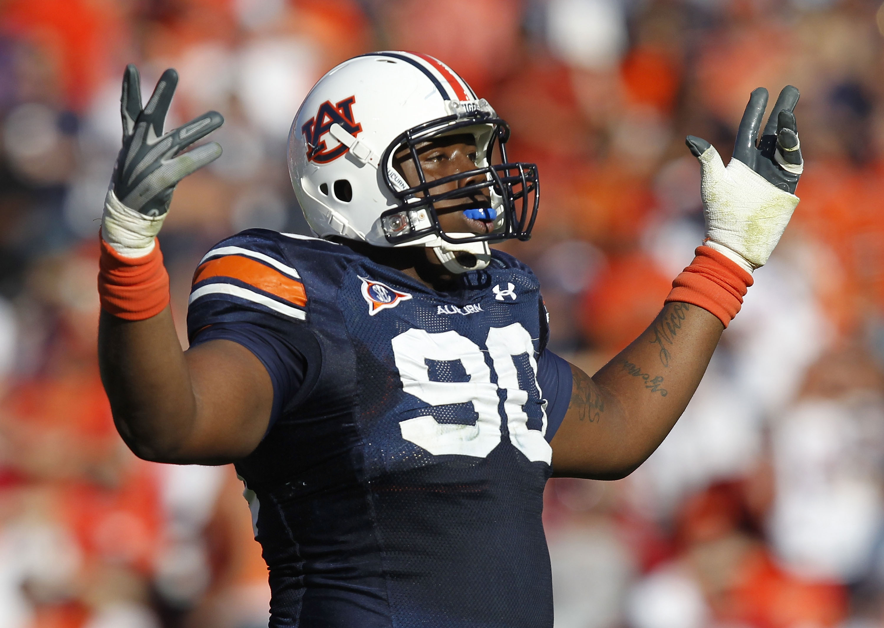 AUBURN, AL - OCTOBER 16:  Defensive lineman Nick Fairley #90 of the Auburn Tigers celebrates a play during the game against the Arkansas Razorbacks at Jordan-Hare Stadium on October 16, 2010 in Auburn, Alabama.  (Photo by Mike Zarrilli/Getty Images)