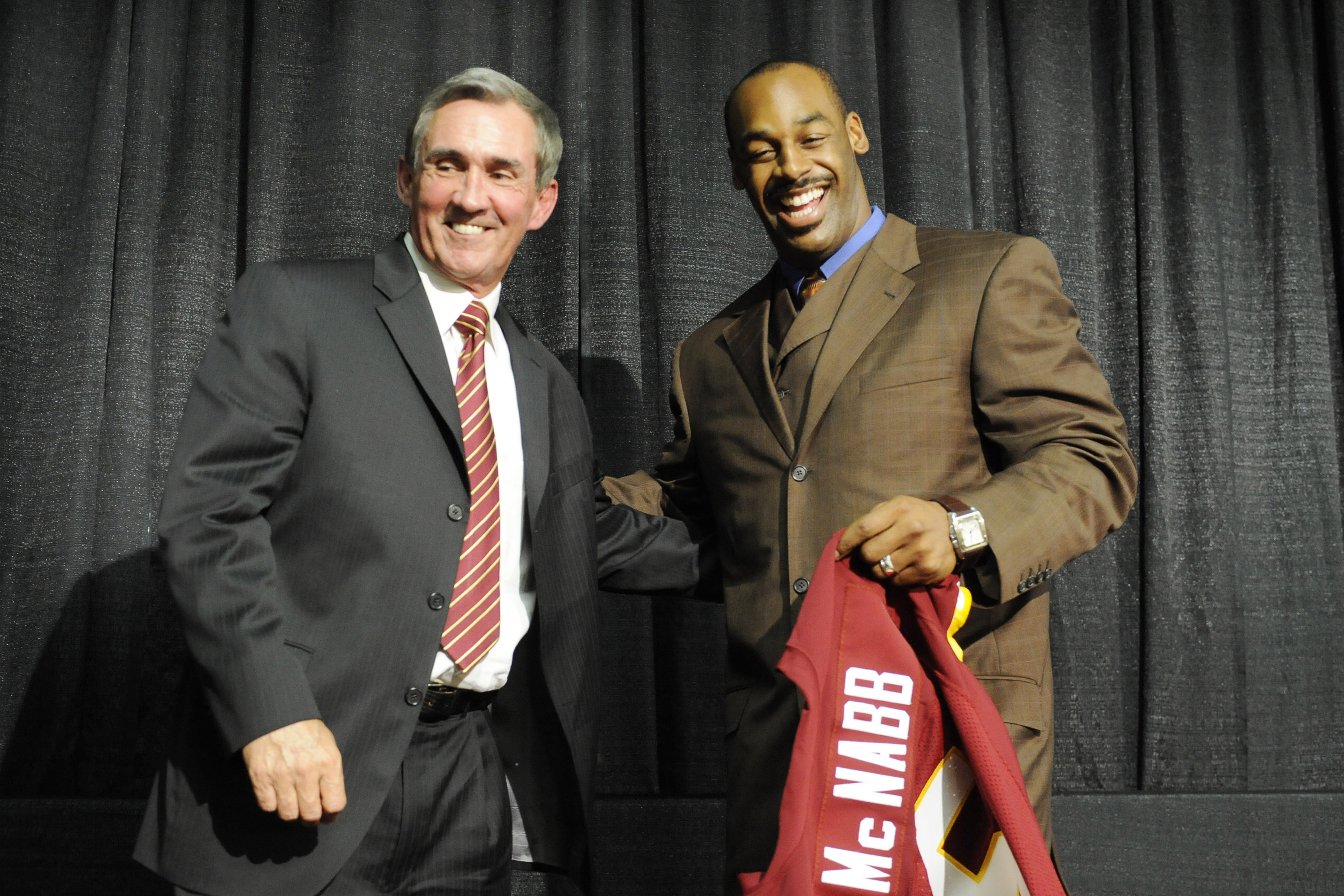 ASHURN, VA - APRIL 6:  Mike Shanahan, head coach of the Washington Redskins presents Donovan McNabb with his new jersey during a press conference on April 6, 2010 at Redskin Park in Ashburn, Virginia.  (Photo by Mitchell Layton/Getty Images)