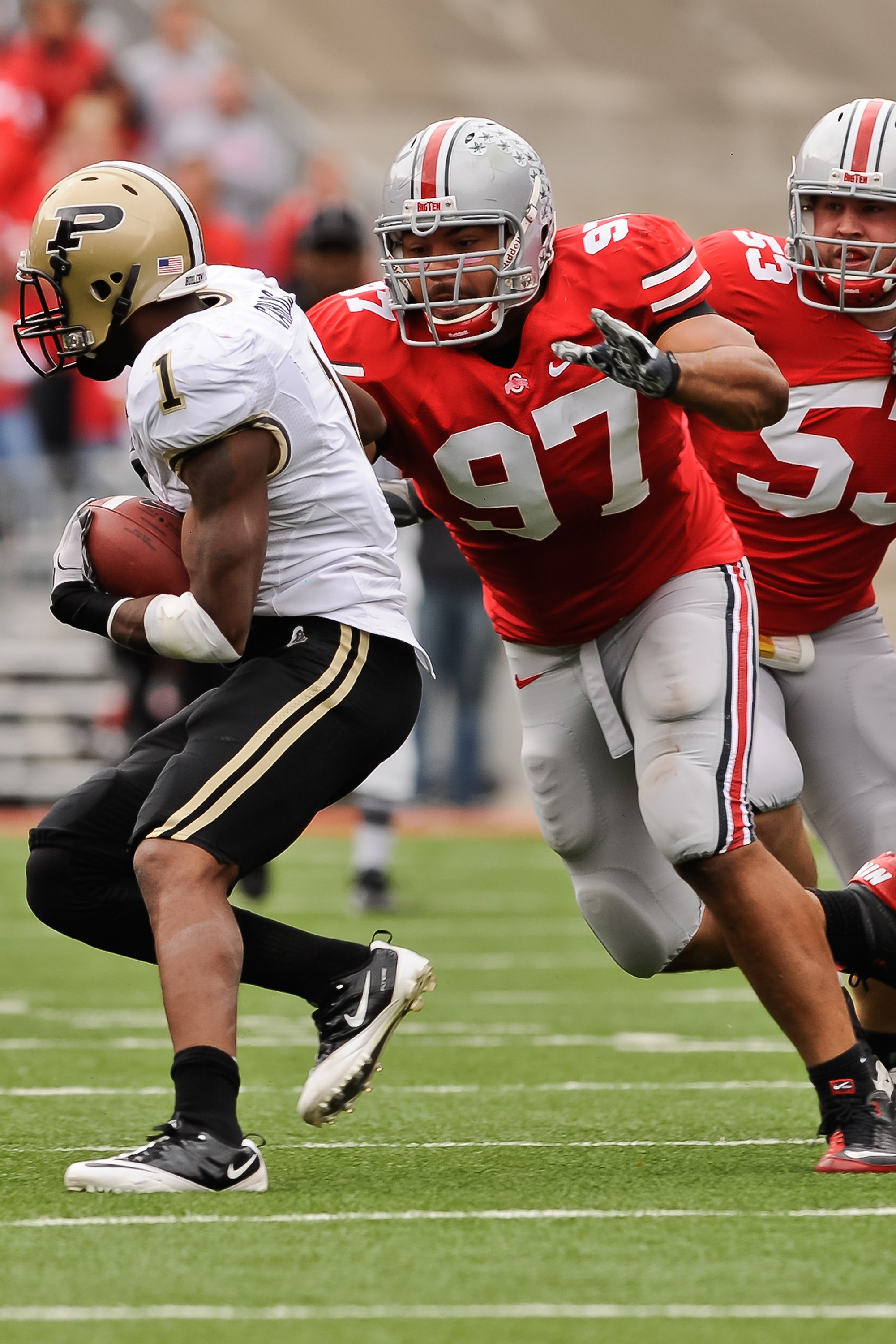 COLUMBUS, OH - OCTOBER 23:  Cameron Heyward #97 of the Ohio State Buckeyes chases down ballcarrier Keith Carlos #1 of the Purdue Boilermakers at Ohio Stadium on October 23, 2010 in Columbus, Ohio.  (Photo by Jamie Sabau/Getty Images)