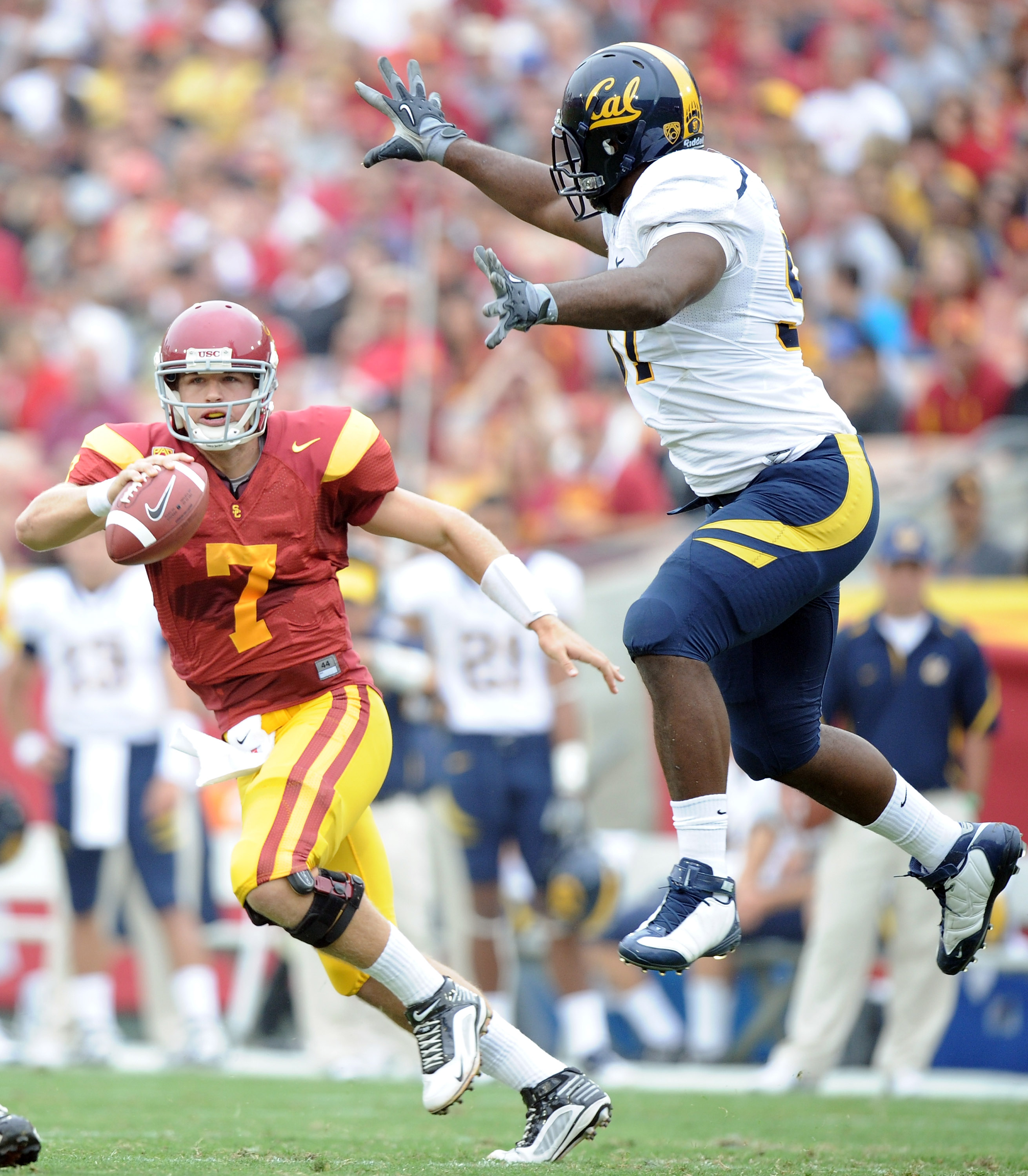 LOS ANGELES, CA - OCTOBER 16:  Matt Barkley #7 of the USC Trojans eludes the rush of Cameron Jordan #97 of the California Golden Bears during the first quarter at Los Angeles Memorial Coliseum on October 16, 2010 in Los Angeles, California.  (Photo by Har