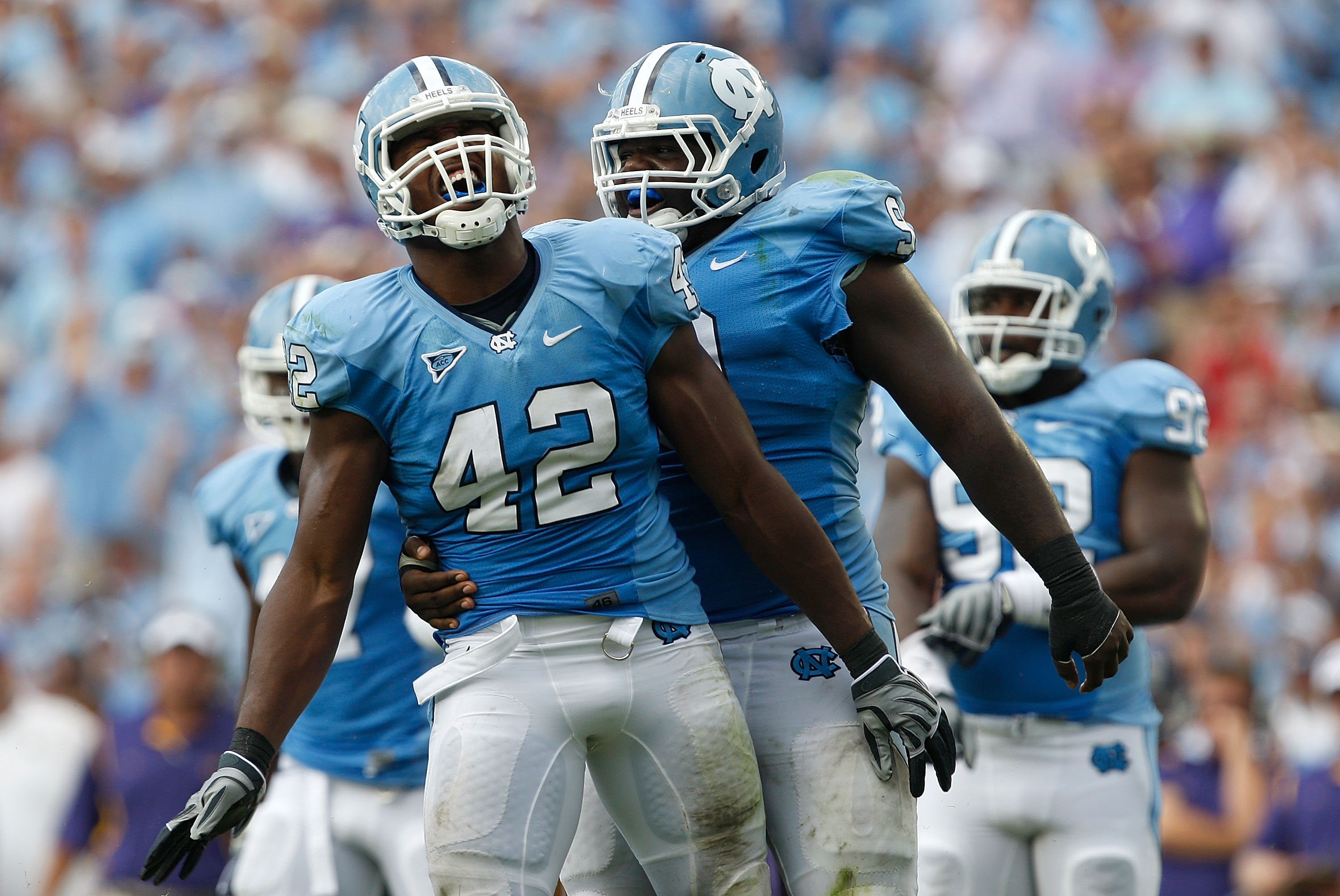 CHAPEL HILL, NC - SEPTEMBER 19:  Robert Quinn #42 of the North Carolina Tar Heels celebrates after a sack with teammate Marvin Austin #9 against the East Carolina Pirates at Kenan Stadium on September 19, 2009 in Chapel Hill, North Carolina.  (Photo by St