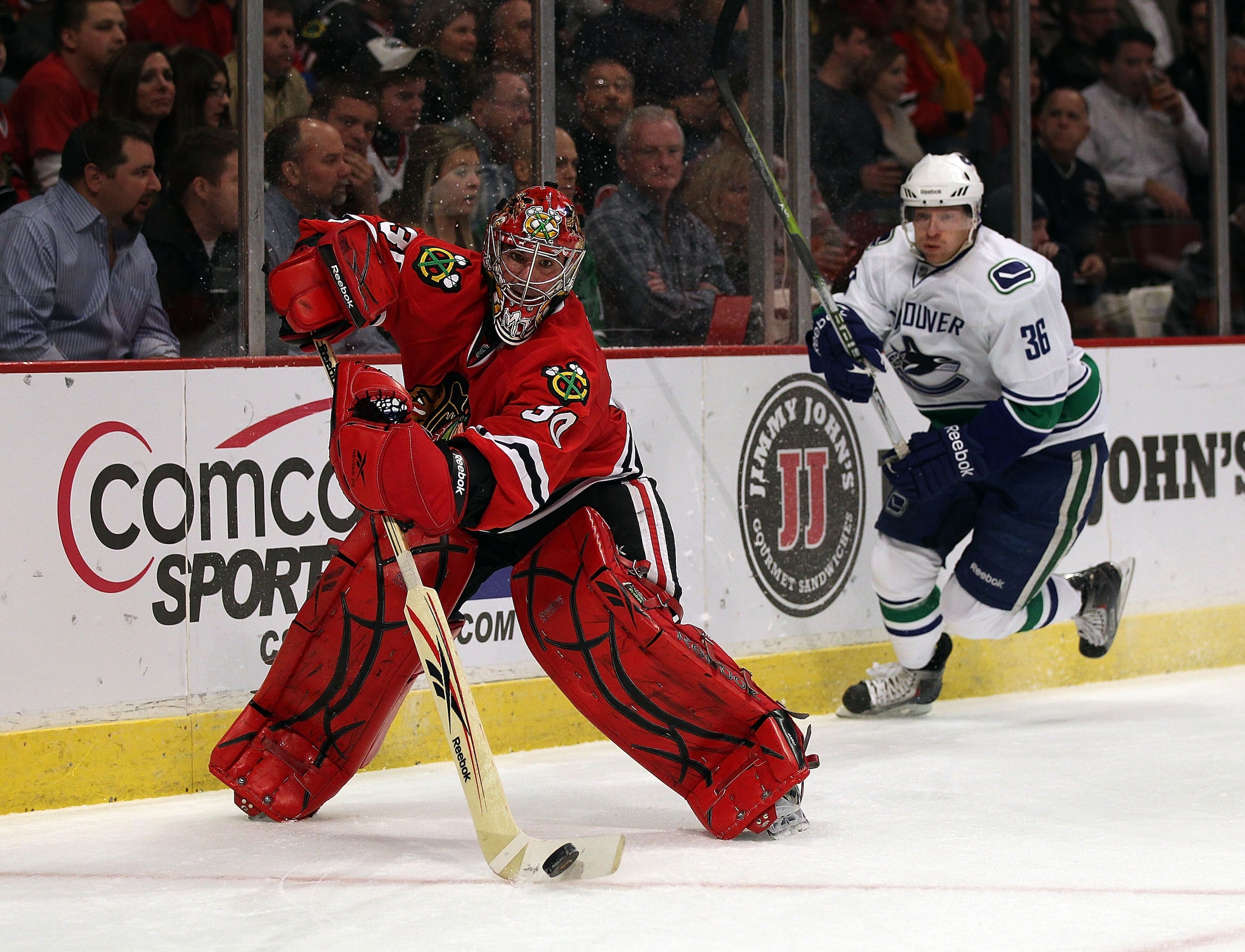 CHICAGO, IL - DECEMBER 03: Marty Turco #30 of the Chicago Blackhawks skates behind the net to clear the puck as Jannik Hansen #36 of the Vancouver Canucks closes in at the United Center on December 3, 2010 in Chicago, Illinois. (Photo by Jonathan Daniel/G CHICAGO, IL - DECEMBER 03: Marty Turco #30 of the Chicago Blackhawks skates behind the net to clear the puck as Jannik Hansen #36 of the Vancouver Canucks closes in at the United Center on December 3, 2010 in Chicago, Illinois. (Photo by Jonathan Daniel/G