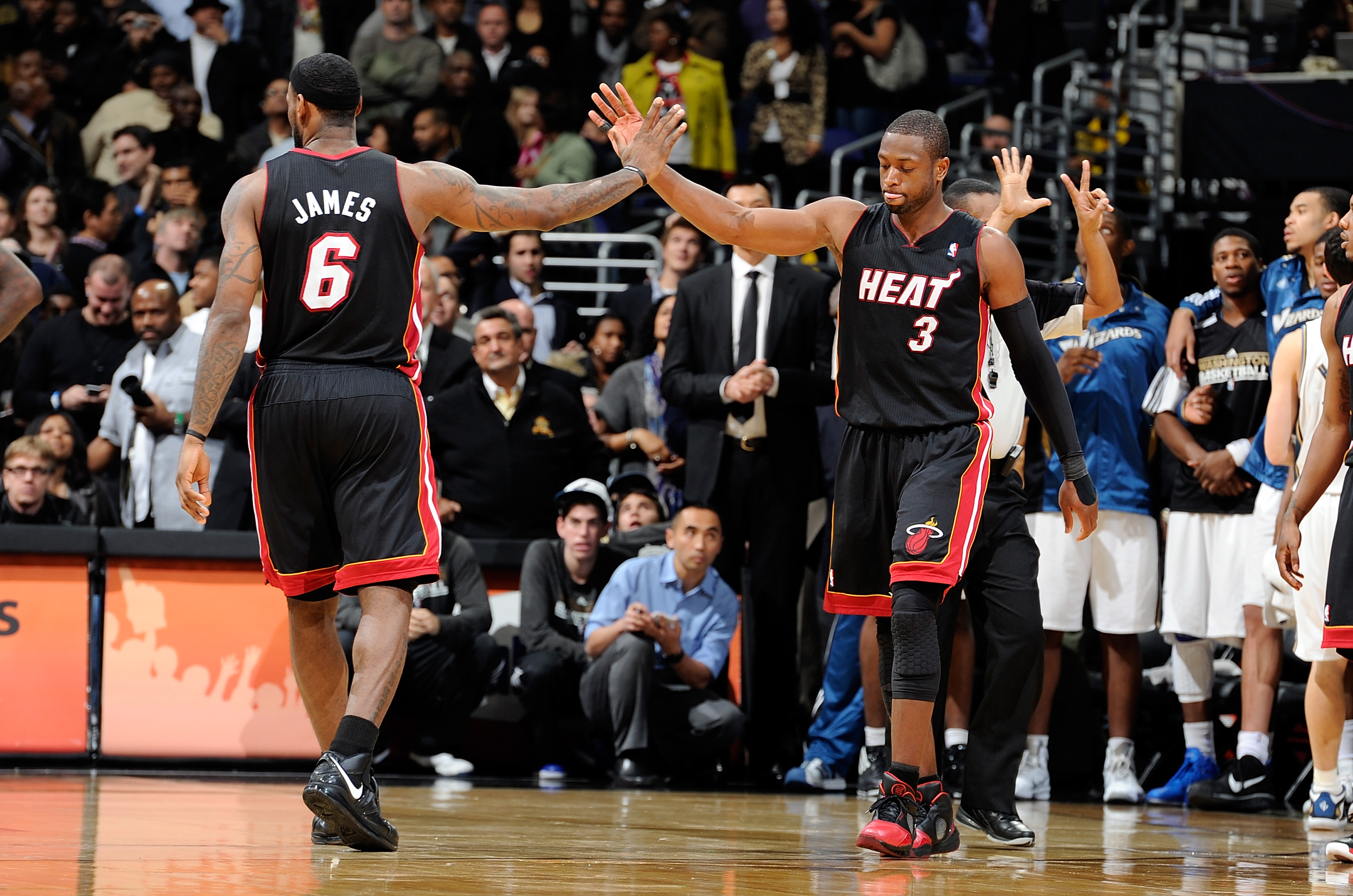 WASHINGTON - DECEMBER 18:  LeBron James #6 congratulates Dwyane Wade #3 after drawing a foul in the fourth quarter against the Washington Wizards at the Verizon Center on December 18, 2010 in Washington, DC. NOTE TO USER: User expressly acknowledges and a