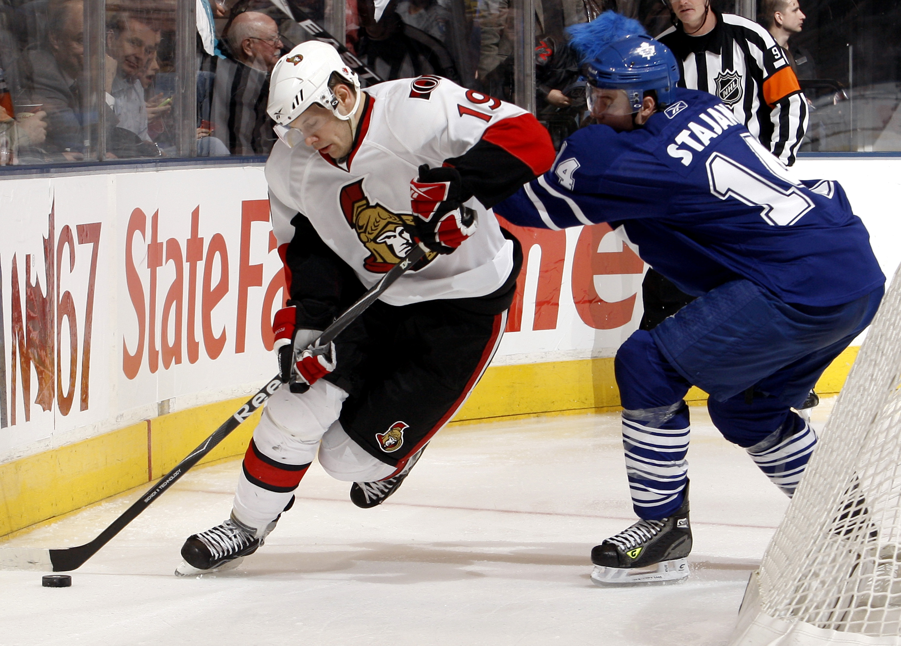 TORONTO - DECEMBER 14:  Matt Stajan #14 of the Toronto Maple Leafs runs into Jason Spezza #19 of the Ottawa Senators during action December 14, 2009 at the Air Canada Centre in Toronto, Ontario, Canada. (Photo by Abelimages/Getty Images)