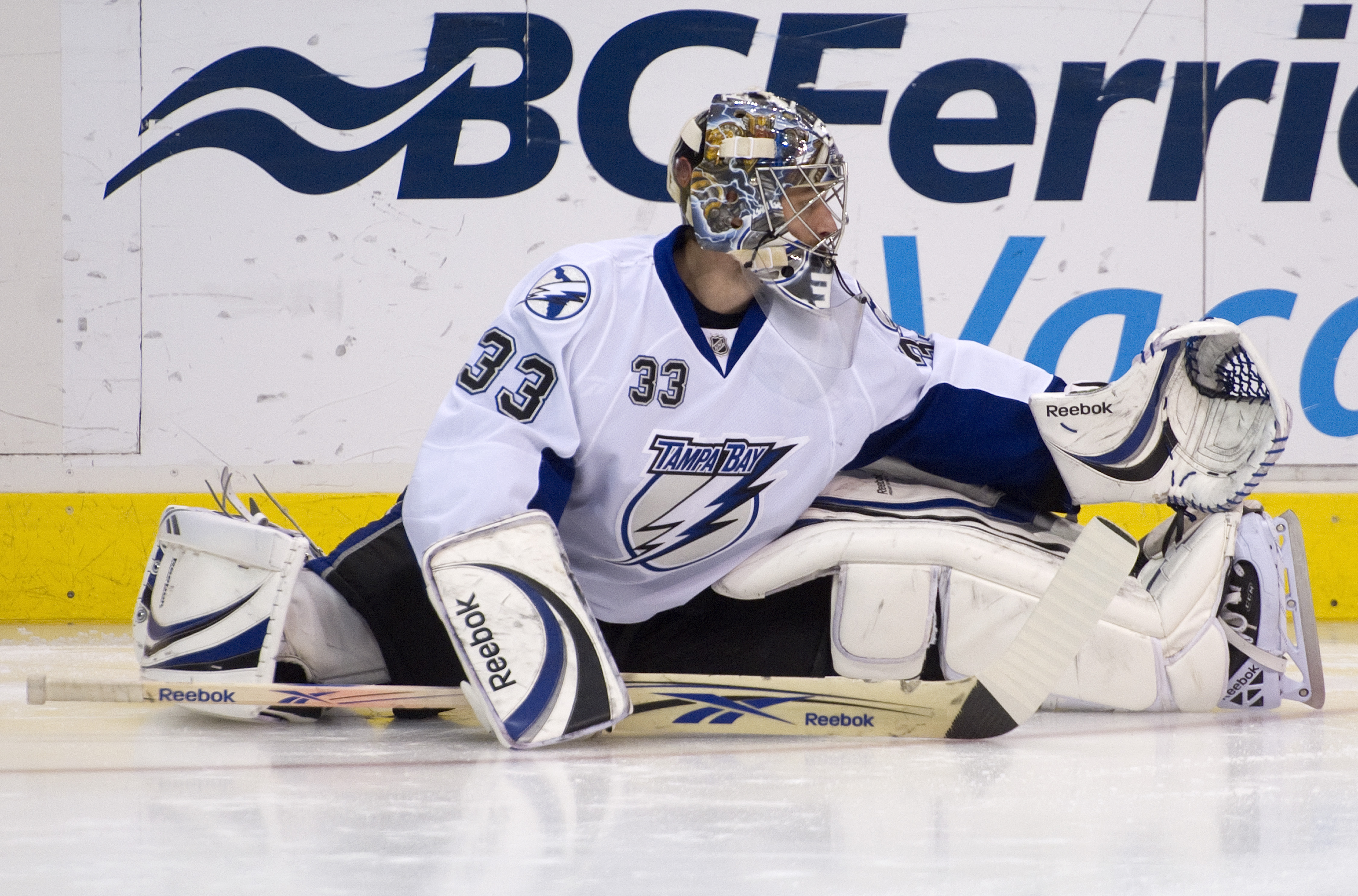 VANCOUVER, CANADA - DECEMBER 11: Goalie Dan Ellis #33 of the Tampa Bay Lightning stretches during the pre-game warmup prior to NHL action on December 11, 2010 against the Vancouver Canucks at Rogers Arena in Vancouver, BC, Canada.  (Photo by Rich Lam/Gett