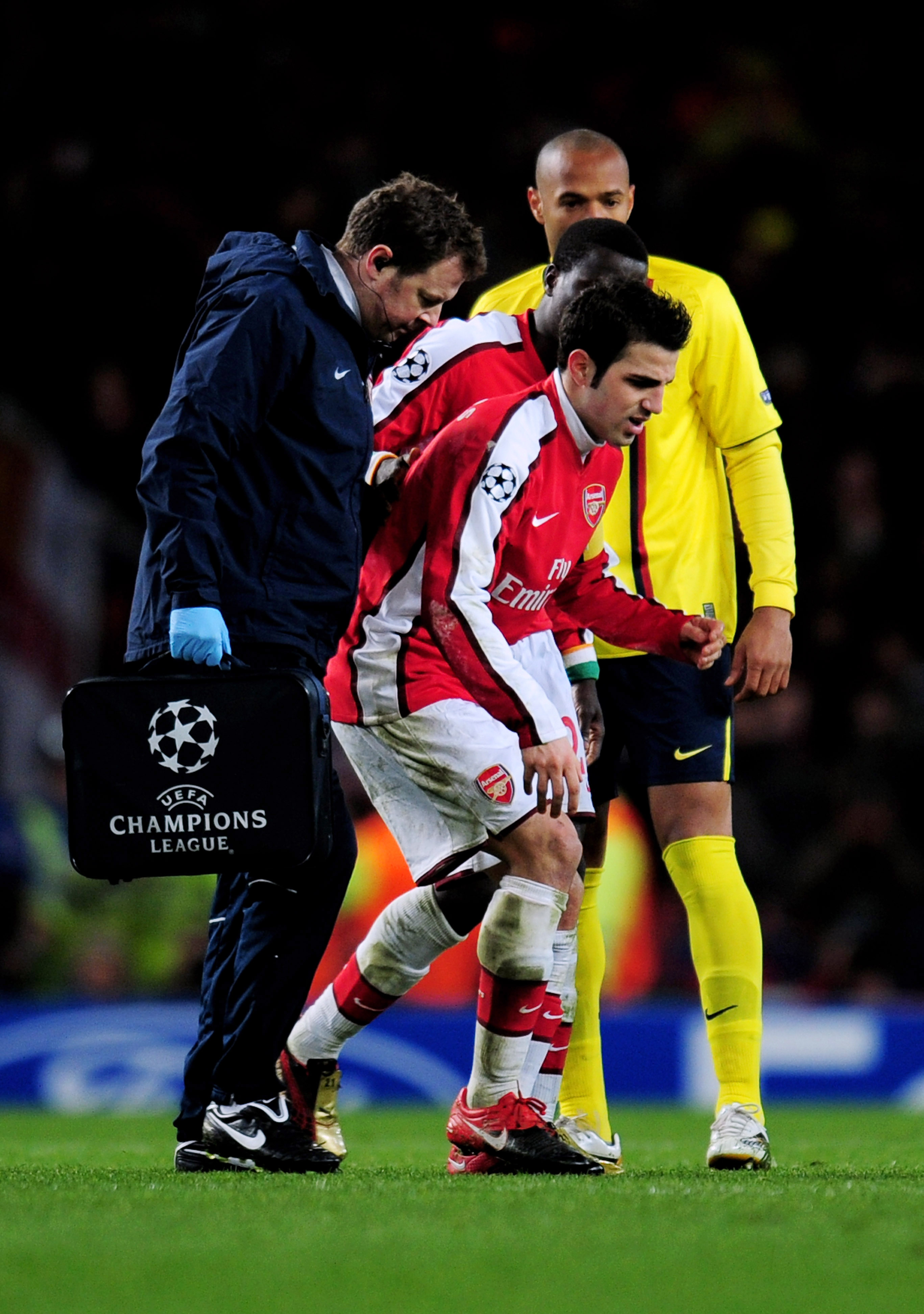 LONDON, ENGLAND - MARCH 31:  Cesc Fabregas of Arsenal hobbles off the pitch injured to receive treatment after levelling the scores at 2-2 from the penalty spot during the UEFA Champions League quarter final first leg match between Arsenal and FC Barcelon
