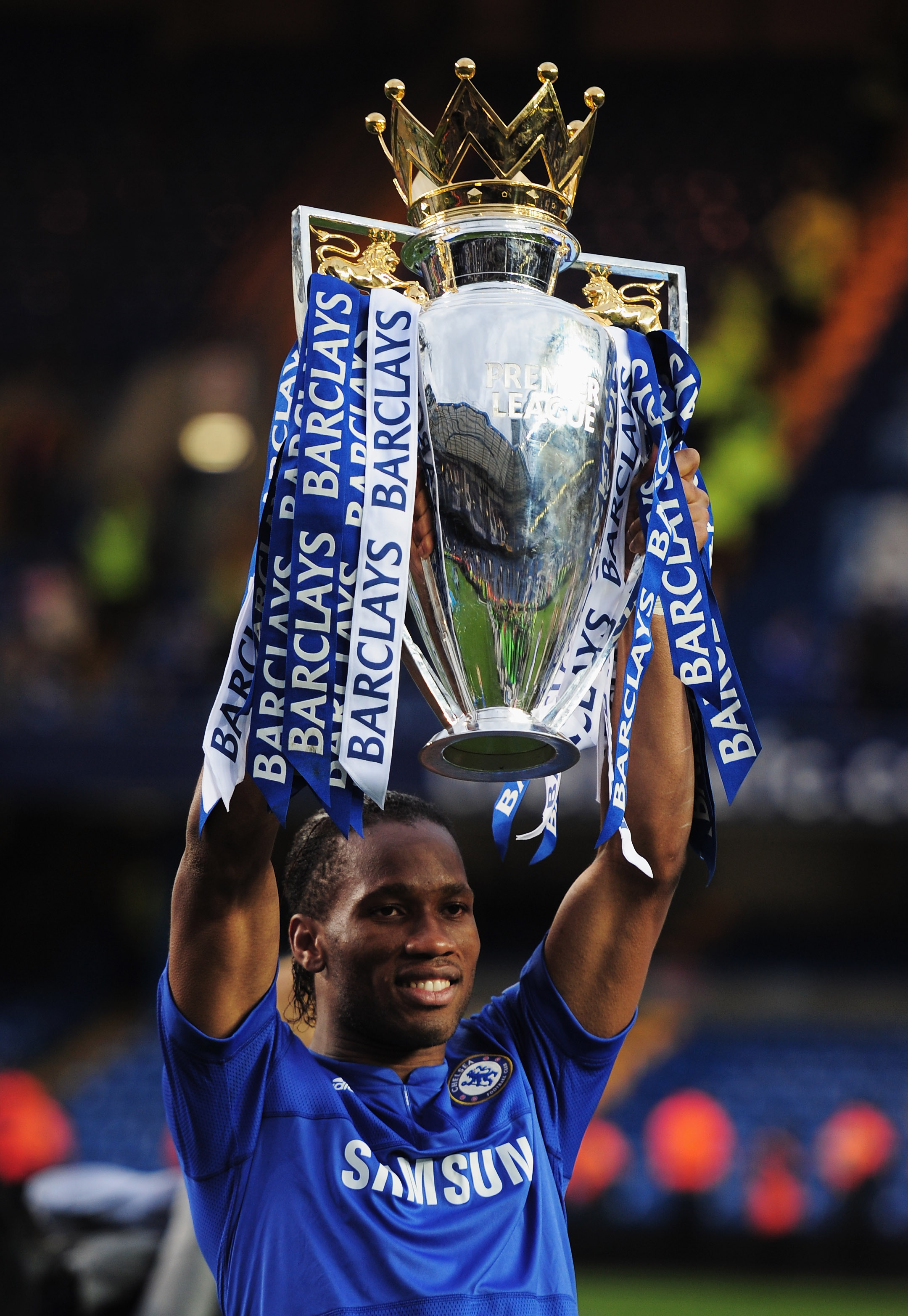 LONDON, ENGLAND - MAY 09:  Didier Drogba of Chelsea celebrates with the trophy as they win the title after the Barclays Premier League match between Chelsea and Wigan Athletic at Stamford Bridge on May 9, 2010 in London, England. Chelsea won 8-0 to win th