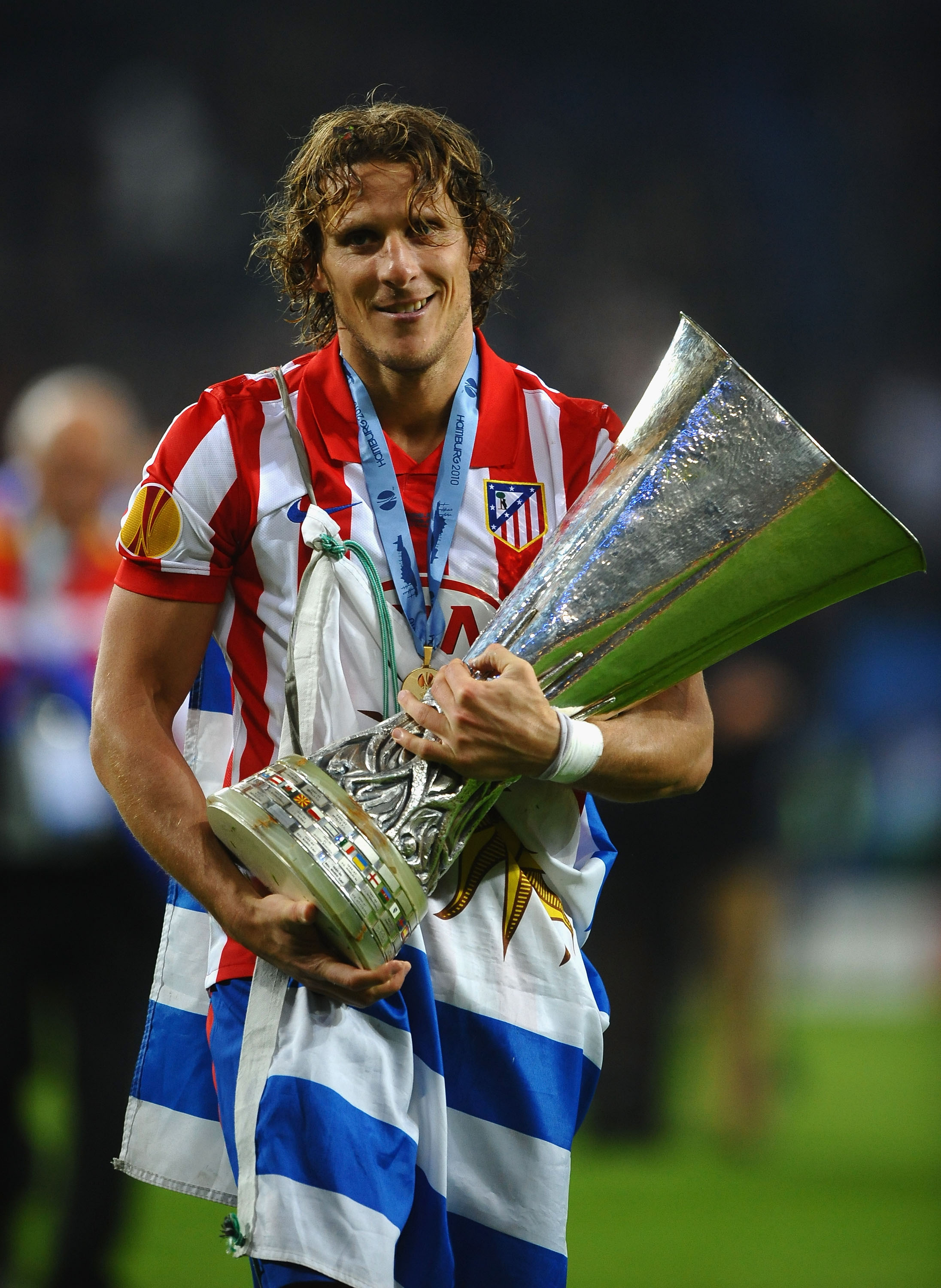 HAMBURG, GERMANY - MAY 12: Diego Forlan of Atletico Madrid holds the UEFA Europa League trophy following his team's victory after extra time at the end of the UEFA Europa League final match between Atletico Madrid and Fulham at HSH Nordbank Arena on May 1