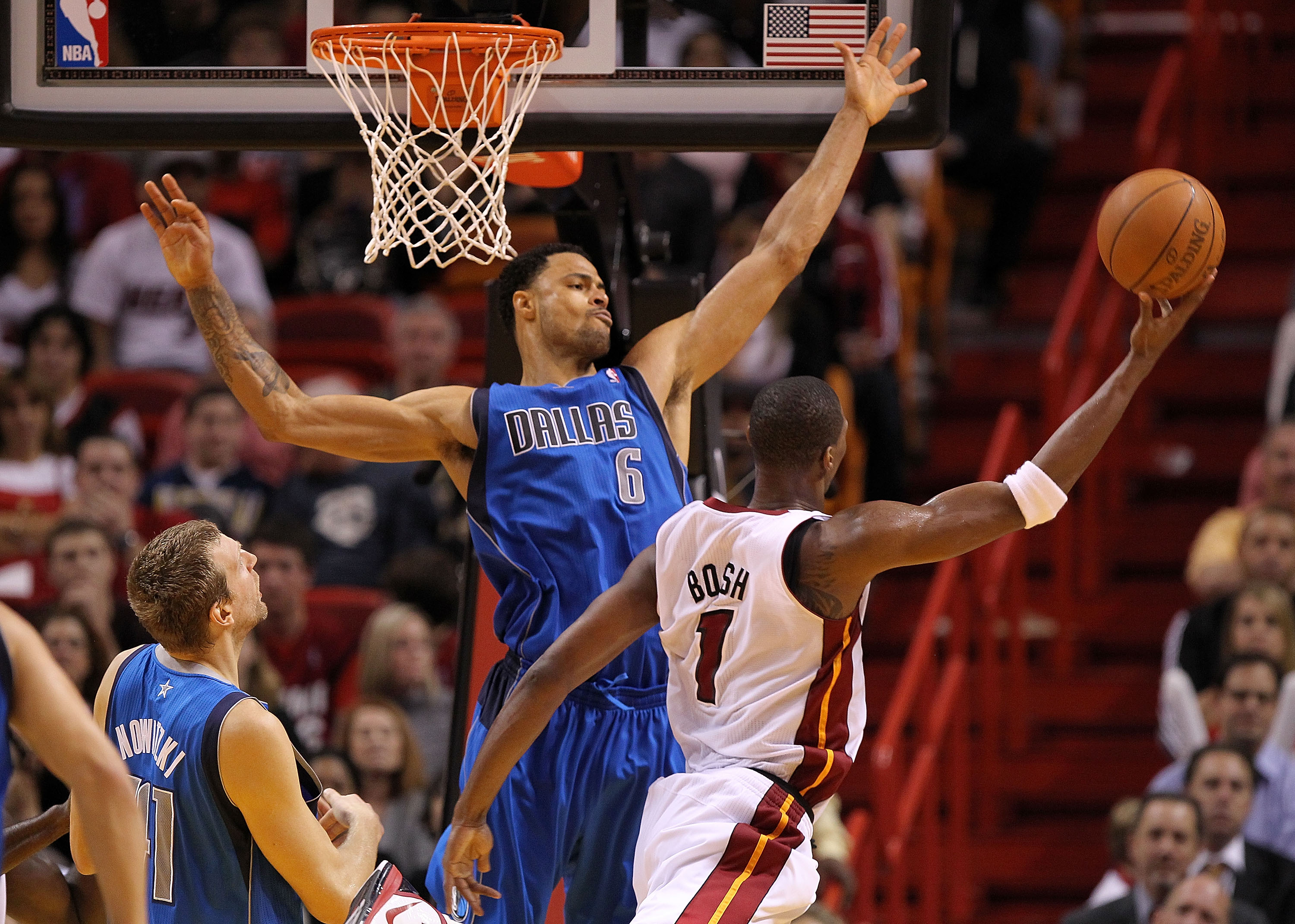 MIAMI, FL - DECEMBER 20:  Chris Bosh #1 of the Miami Heat shoots over Tyson Chandler #6 of the Dallas Mavericks during a game at American Airlines Arena on December 20, 2010 in Miami, Florida. NOTE TO USER: User expressly acknowledges and agrees that, by