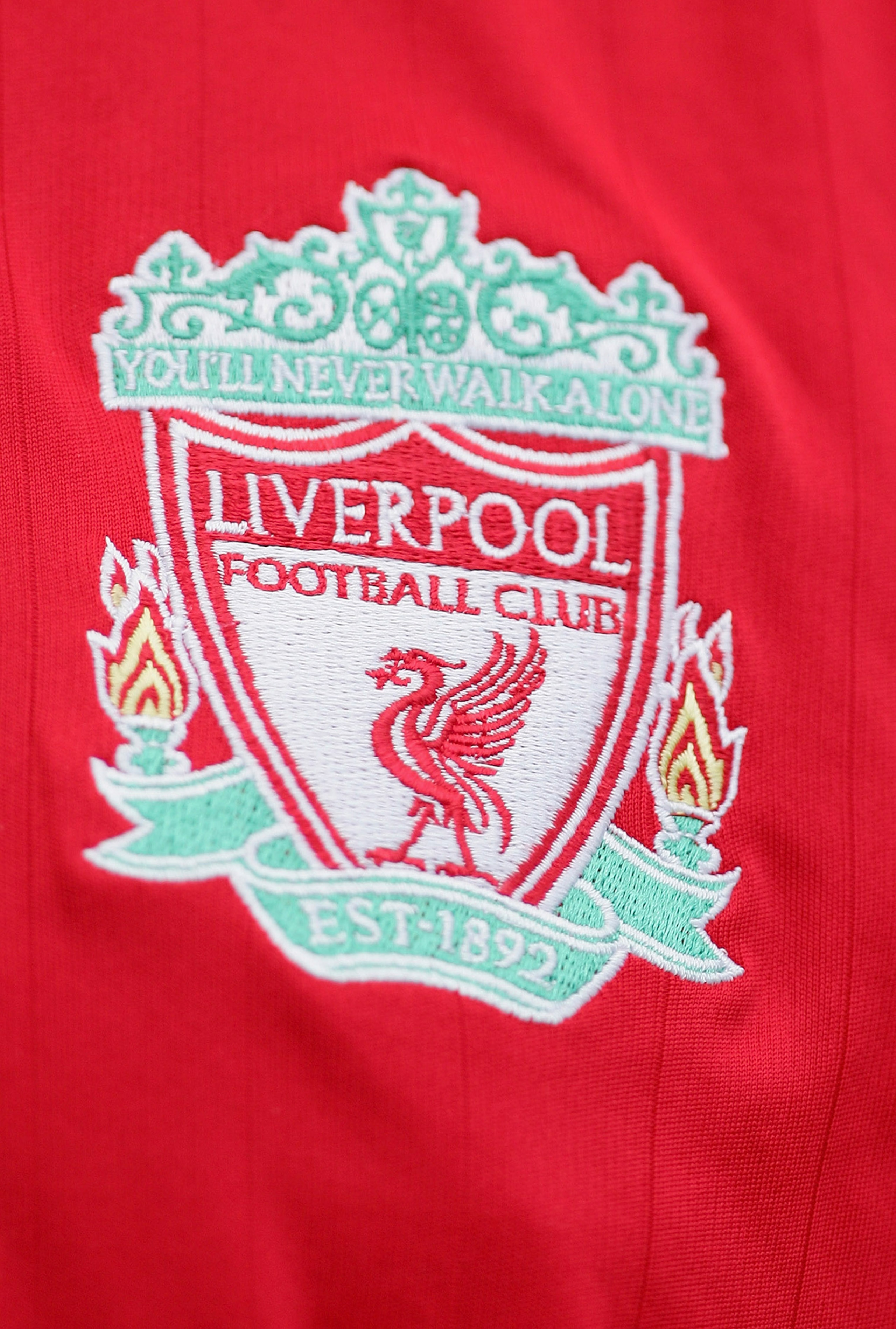 LIVERPOOL, UNITED KINGDOM - SEPTEMBER 23: The Liverpool badge on a fans shirt during the Barclays Premiership match between Liverpool and Tottenham Hotspur at Anfield on September 23, 2006 in Liverpool, England. (Photo by Laurence Griffiths/Getty Images) LIVERPOOL, UNITED KINGDOM - SEPTEMBER 23: The Liverpool badge on a fans shirt during the Barclays Premiership match between Liverpool and Tottenham Hotspur at Anfield on September 23, 2006 in Liverpool, England. (Photo by Laurence Griffiths/Getty Images)