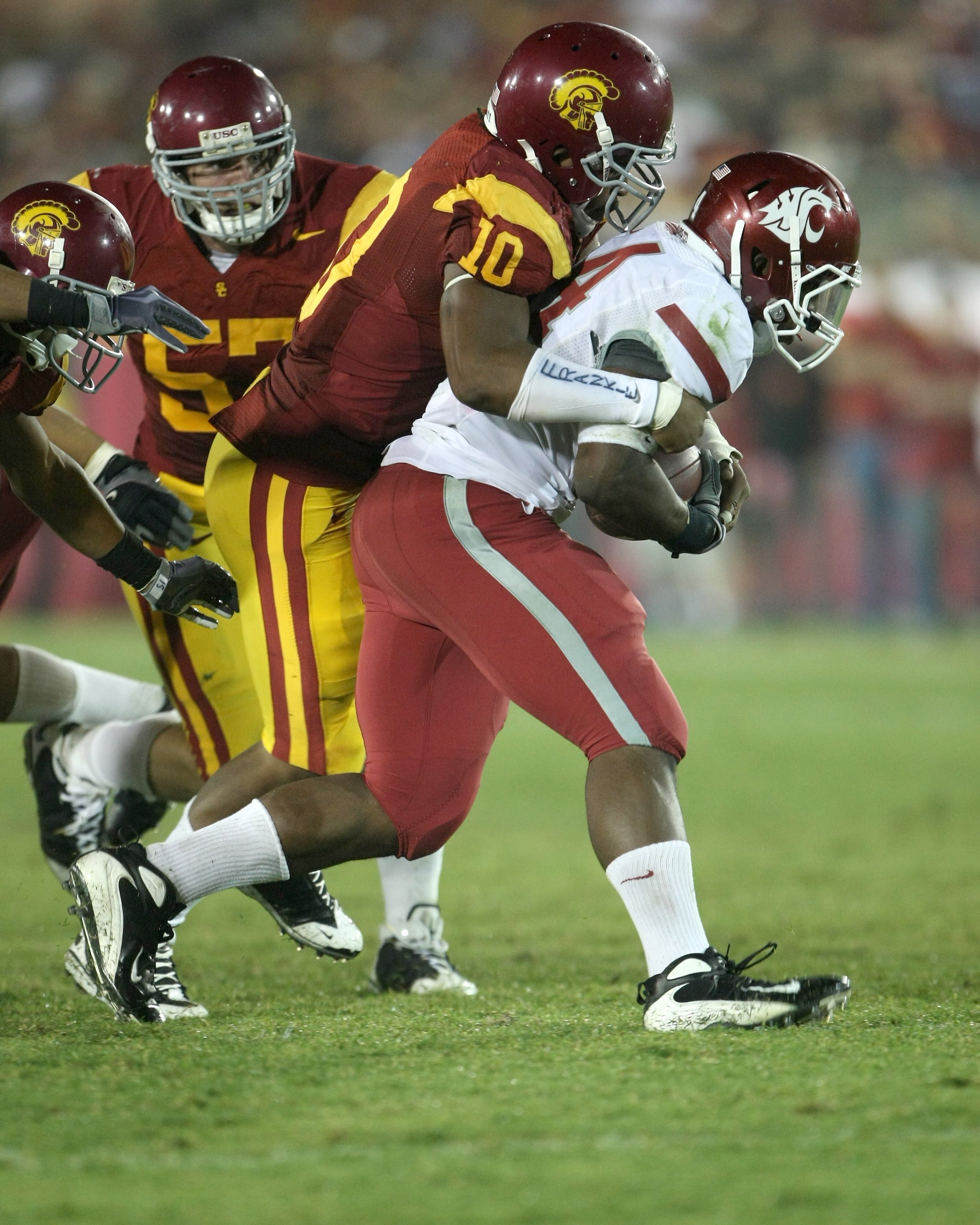 LOS ANGELES, CA - SEPTEMBER 26:  Linebacker Jarvis Jones #10 of the USC Trojans tackles running back Logwone Mitz #34 of the Washington State Cougars on September 23, 2009 at the Los Angeles Coliseum in Los Angeles, California.  USC won 27-6.  (Photo by S