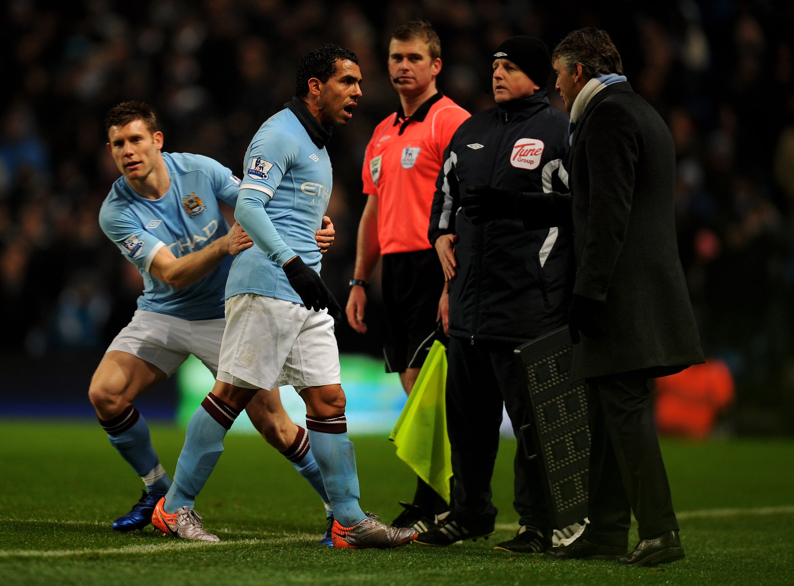 MANCHESTER, UNITED KINGDOM - DECEMBER 04:   Carlos Tevez of Manchester City has words with Manchester City Manager Roberto Mancini after being substituted for team mate James Milner during the Barclays Premier League match between Manchester City and Bolt