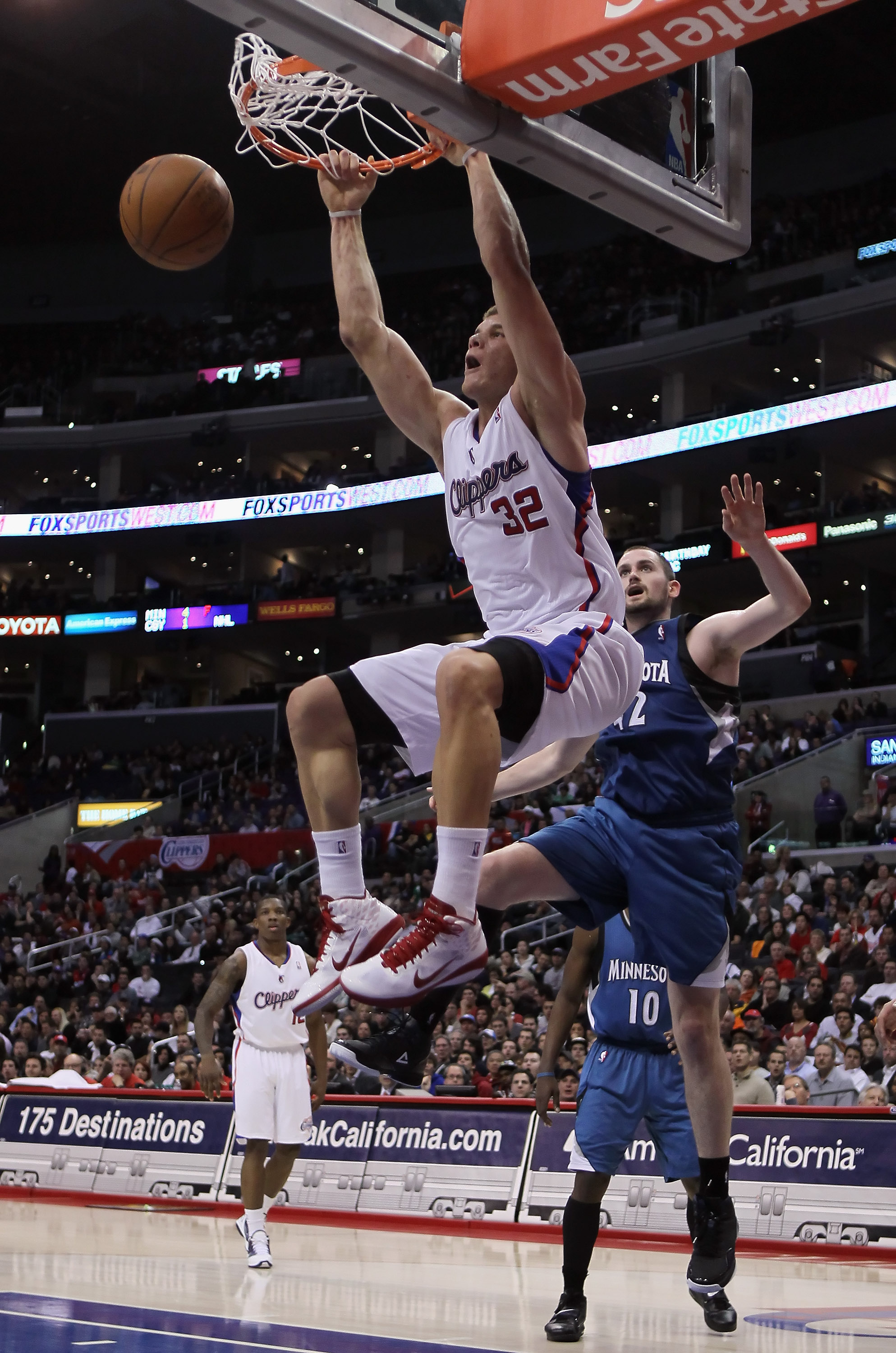 LOS ANGELES, CA - DECEMBER 20:  Blake Griffin #32 of the Los Angeles Clippers drives past Kevin Love #42 of the Minnesota Timberwolves for a dunk during the second half at Staples Center on December 20, 2010 in Los Angeles, California. The Clippers defeat