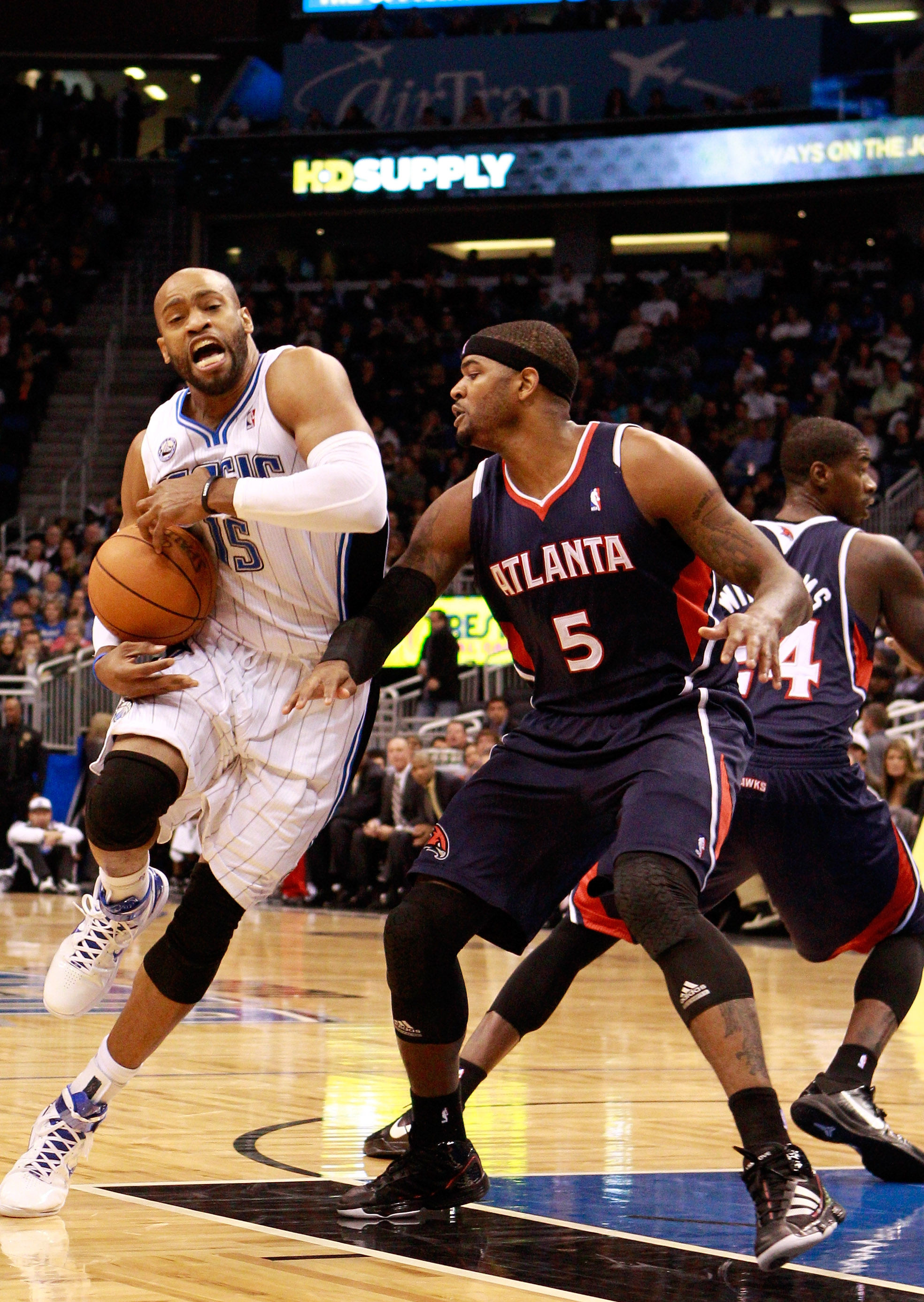 ORLANDO, FL - DECEMBER 06:  Vince Carter, #15 of the Orlando Magic, drives against Josh Smith, #5 of the Atlanta Hawks during the game at Amway Arena on December 6, 2010 in Orlando, Florida. NOTE TO USER: User expressly acknowledges and agrees that, by do