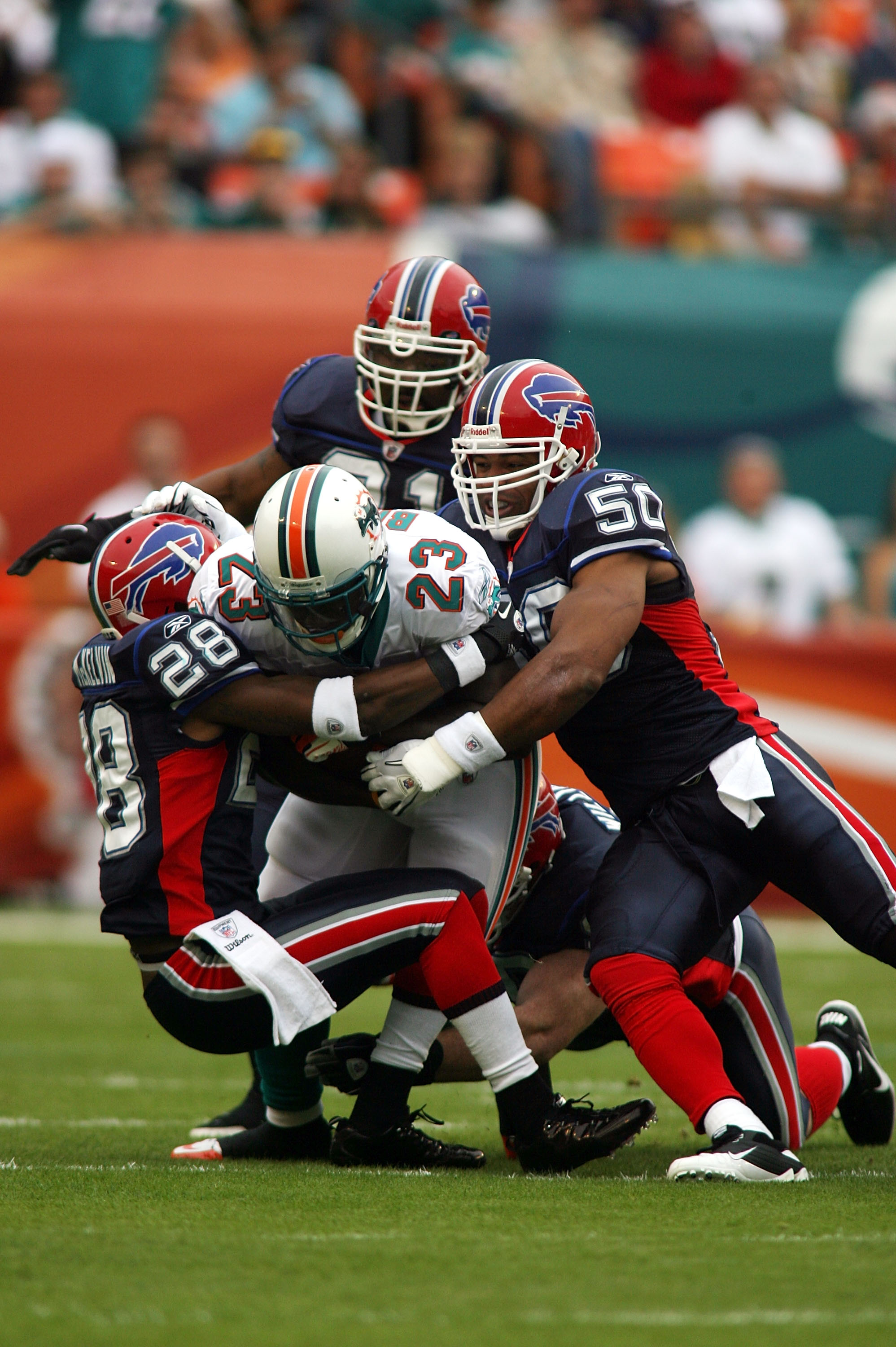 Miami Dolphins wide receiver Brandon Marshall (19) is tackled by Buffalo  Bills Drayton Florence (29) during first half action against The Buffalo  Bills at Sun Life Stadium, in Miami Florida.December 19,2010. The