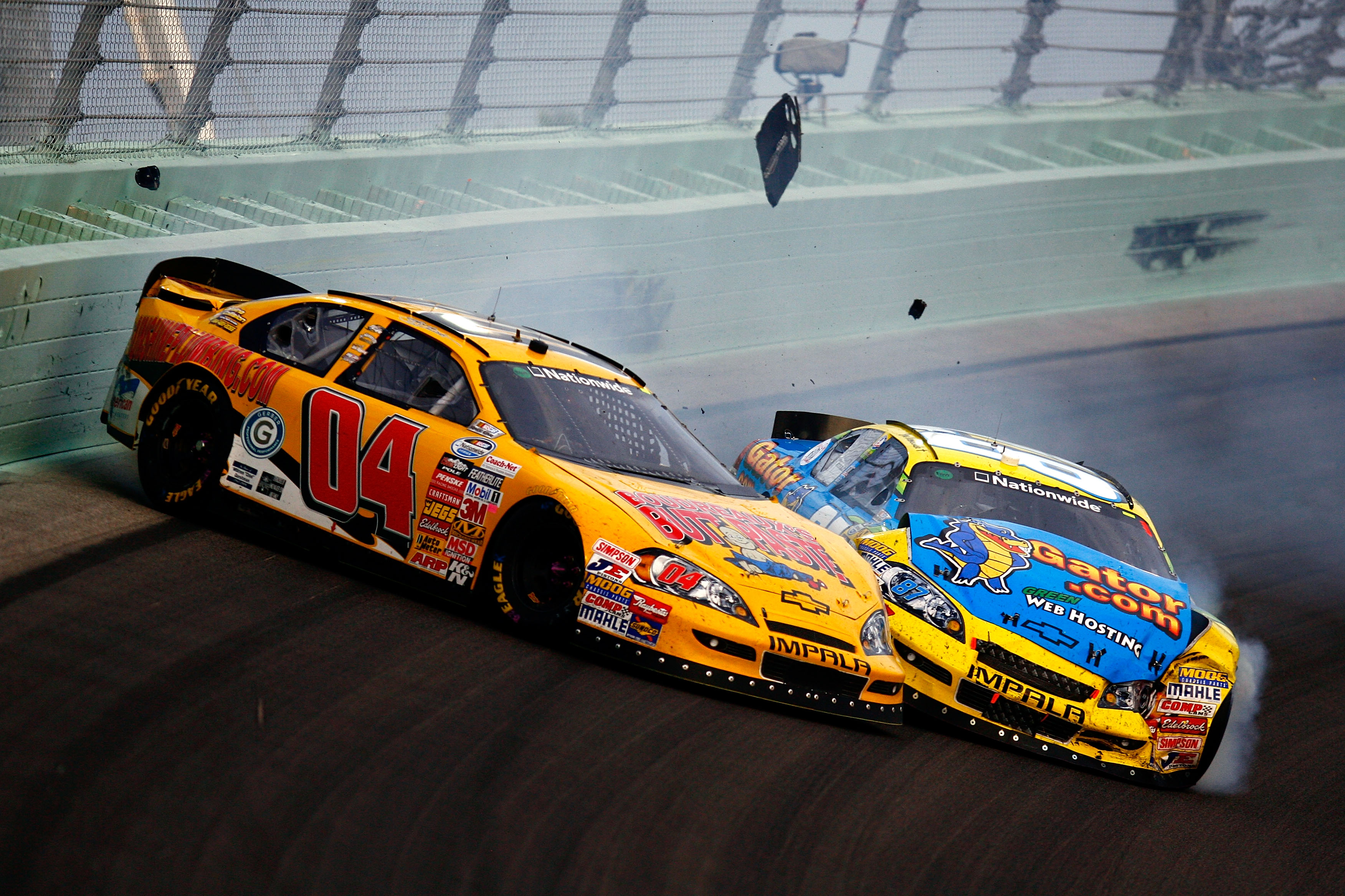 HOMESTEAD, FL - NOVEMBER 20:  Jeremy Clements, driver of the #04 Boudreaux's Butt Paste Chevrolet, and Joe Nemechek, driver of the #87 HostGator.com Chevrolet,  crash after an incident in the NASCAR Nationwide Series Ford 300 at Homestead-Miami Speedway o