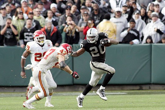 Oakland Raiders running back Darren McFadden (20) pushes off of Kansas City  Chiefs safety Jarrad Page (44) during the first half of an NFL football  game Sunday, Sept. 20, 2009, in Kansas