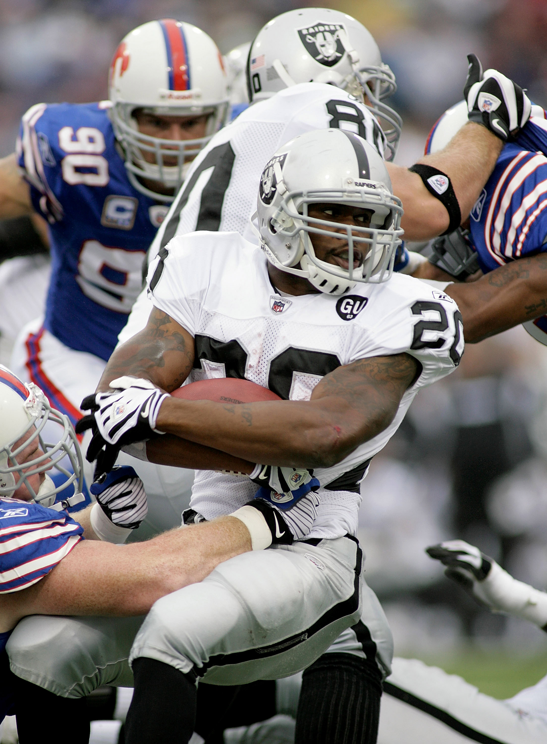 Oakland Raiders running back Darren McFadden (20) pushes off of Kansas City  Chiefs safety Jarrad Page (44) during the first half of an NFL football  game Sunday, Sept. 20, 2009, in Kansas