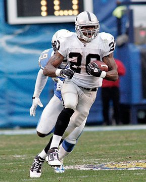 Oakland Raiders running back Darren McFadden (20) pushes off of Kansas City  Chiefs safety Jarrad Page (44) during the first half of an NFL football  game Sunday, Sept. 20, 2009, in Kansas